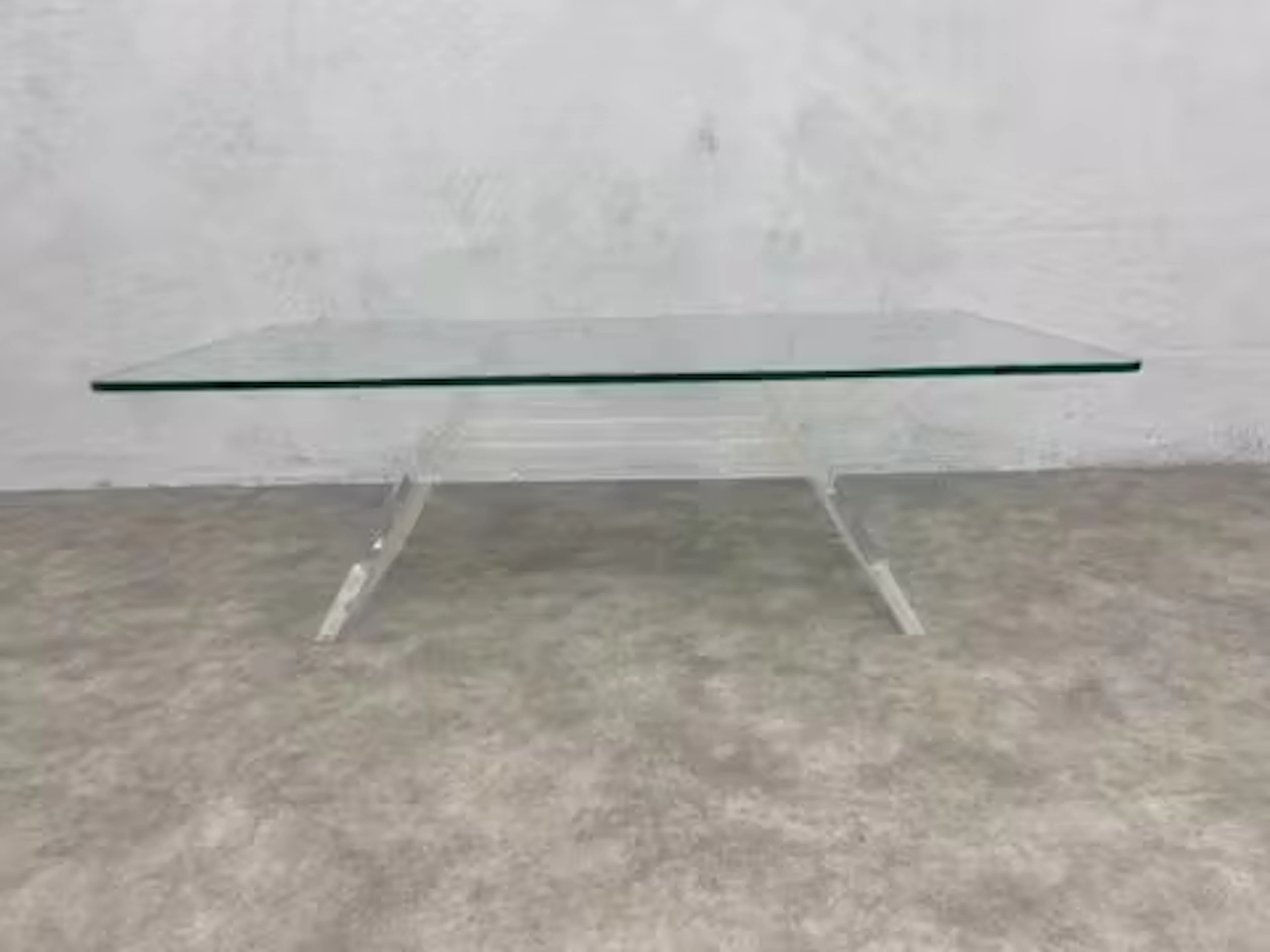 A vintage coffee table with plate glass top on acrylic base. H.36 W.110 D.60cm.