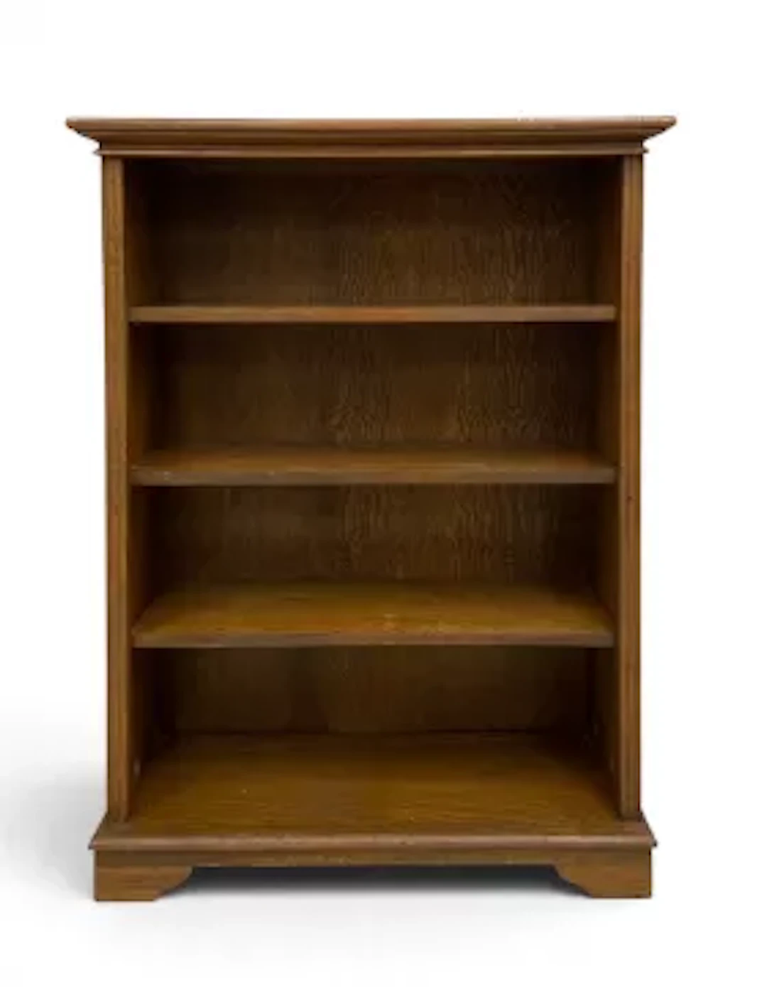 A vintage oak dwarf open bookcase with three shelves on shaped bracket