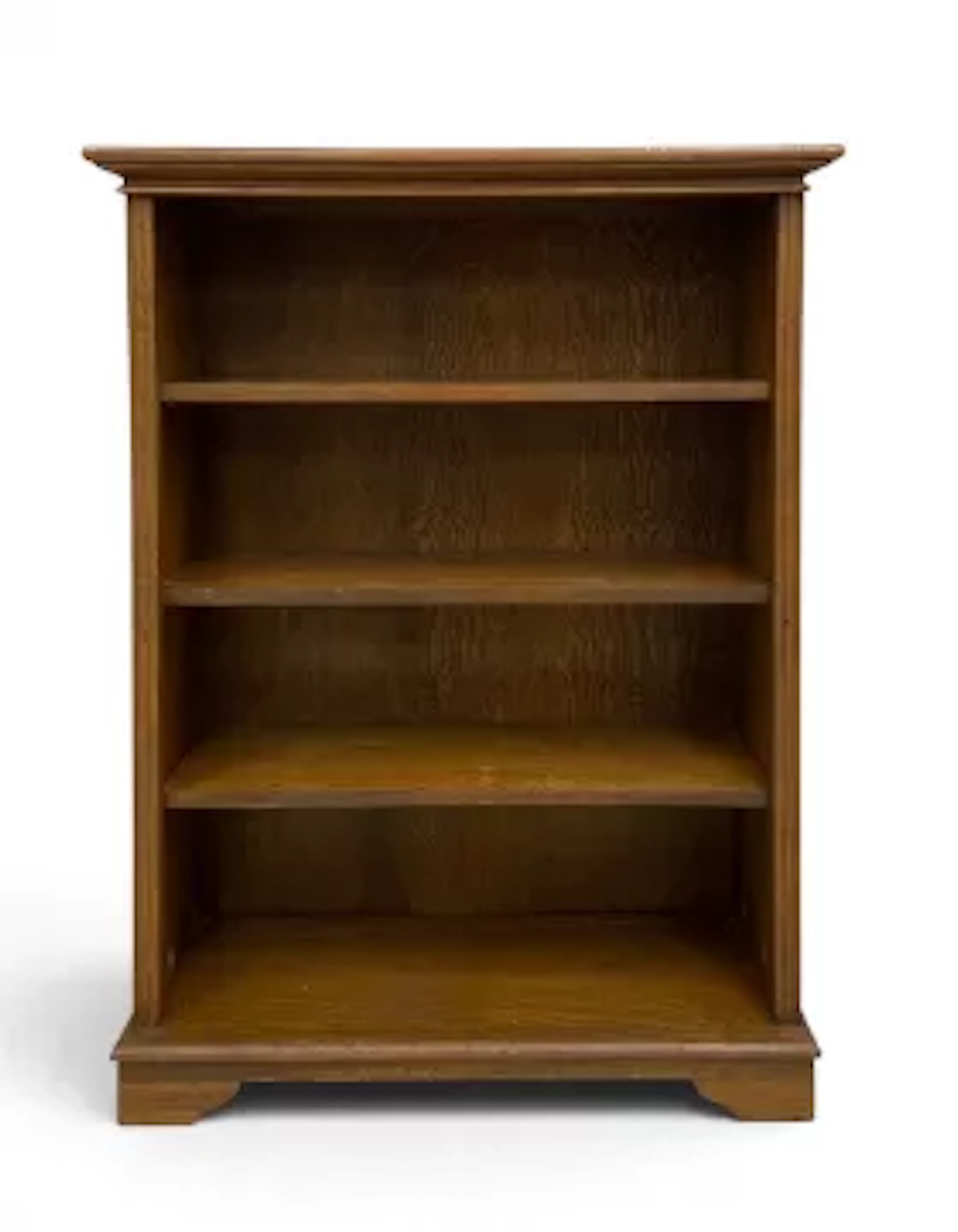 A vintage oak dwarf open bookcase with three shelves on shaped bracket
