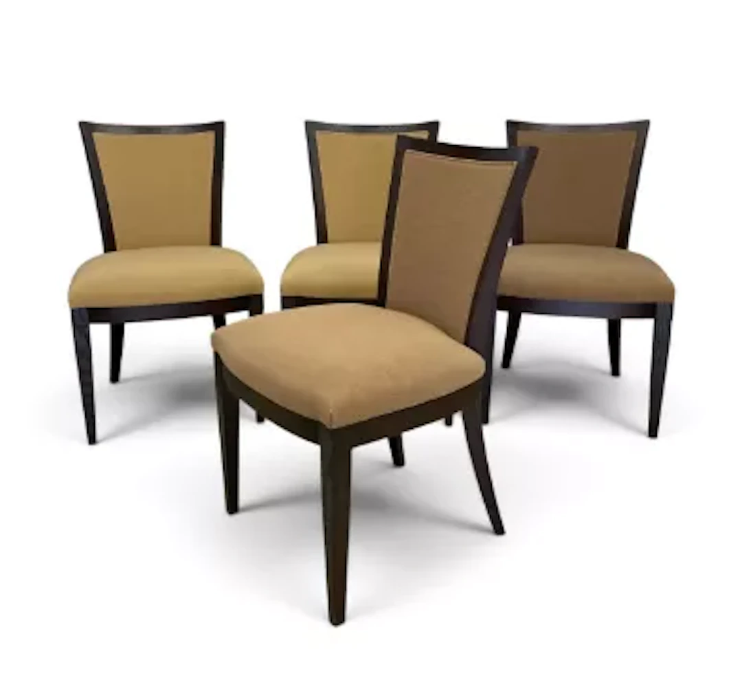 A set of four contemporary teak dining chairs in calico upholstery.