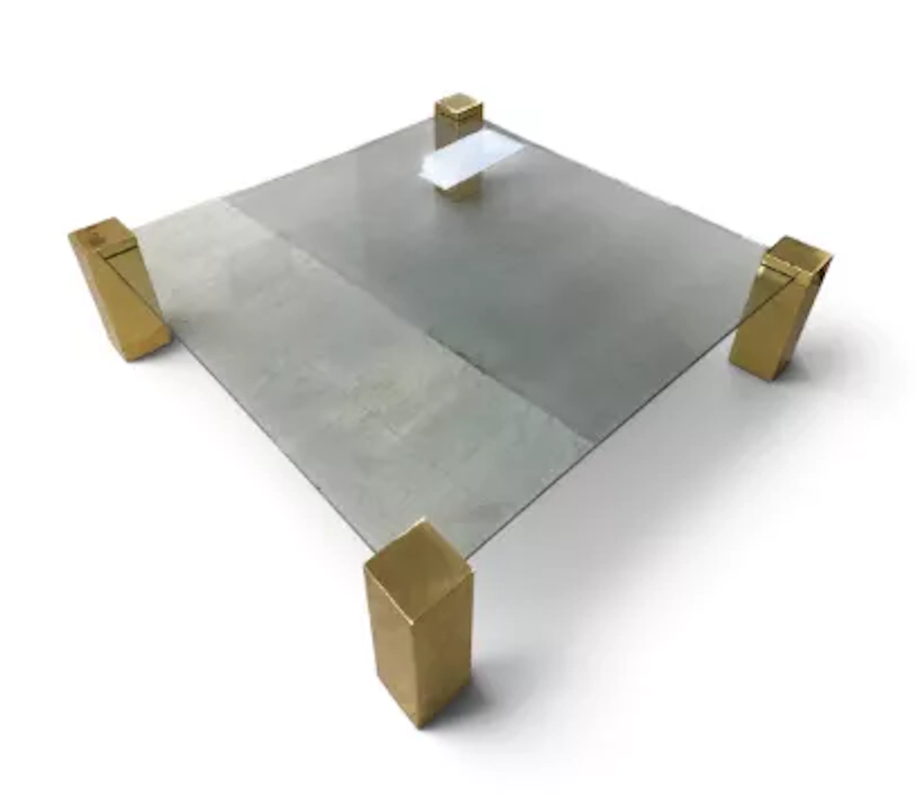 A contemporary brass and plate glass coffee table on block supports.