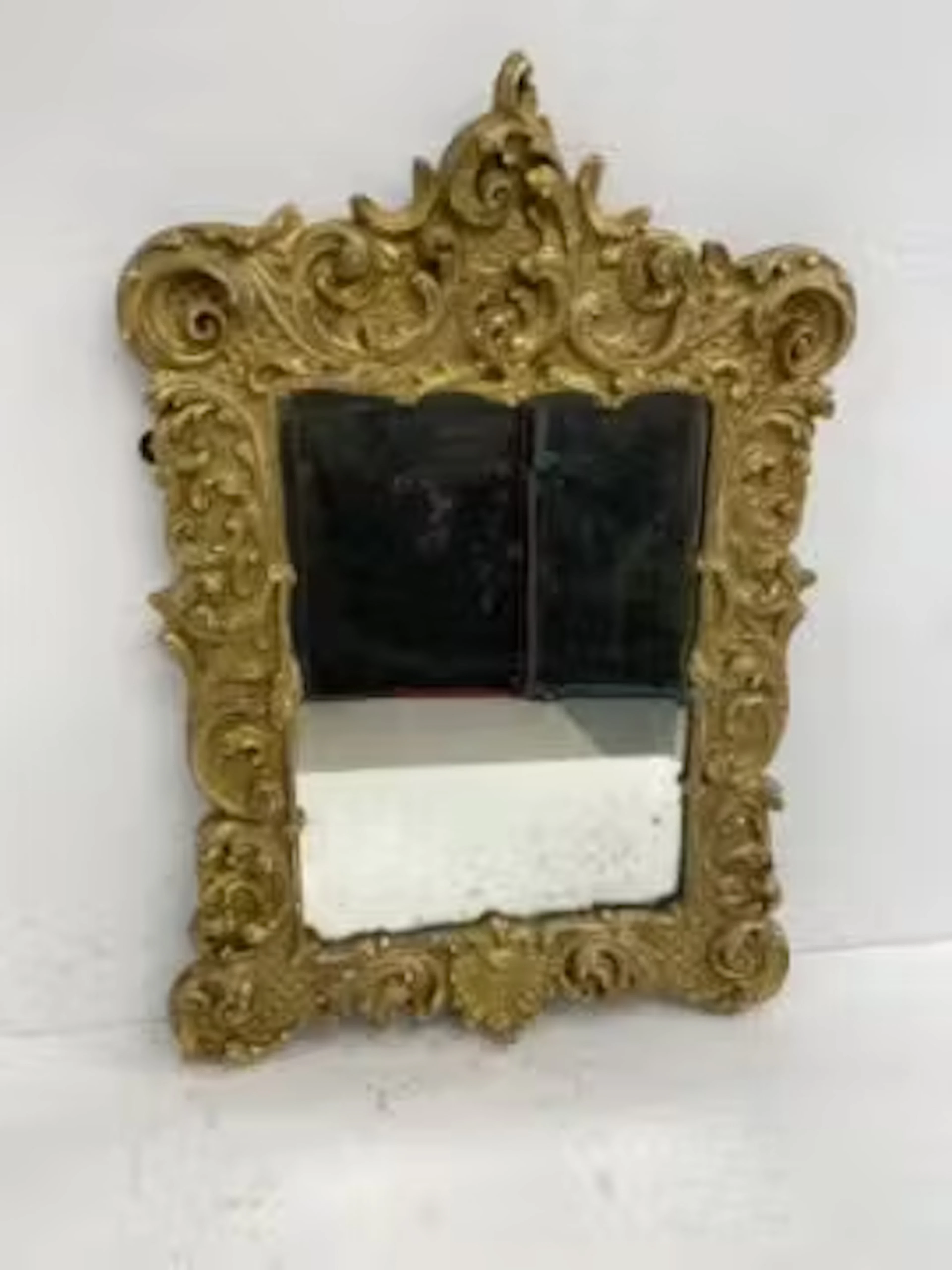 An early 20th century carved giltwood Rococo style wall mirror with