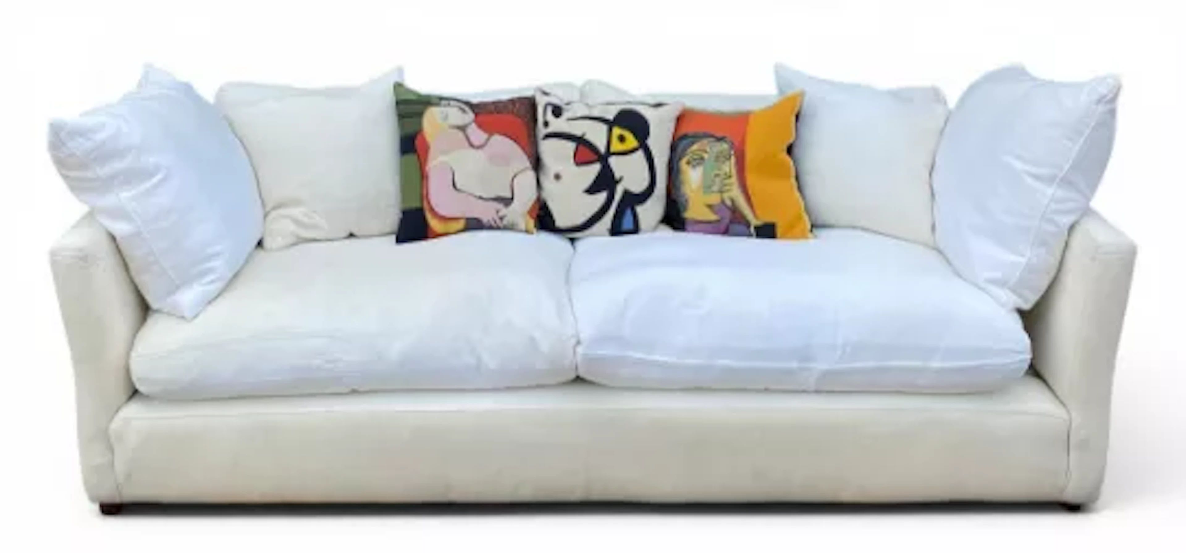 A contemporary three seater sofa with down filled cushions and a set