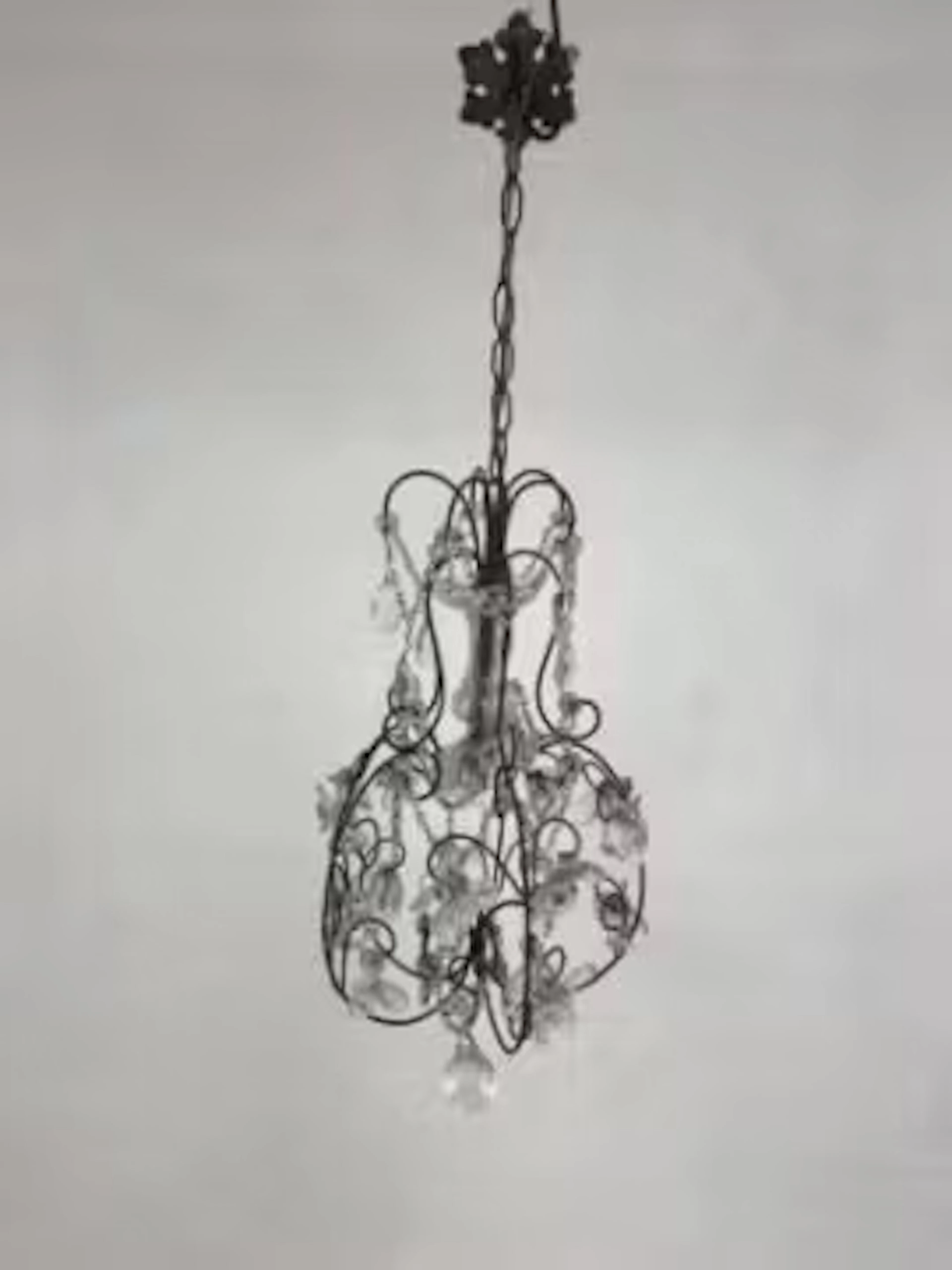 A French 19th century wrought iron and cut glass chandelier with scrolling