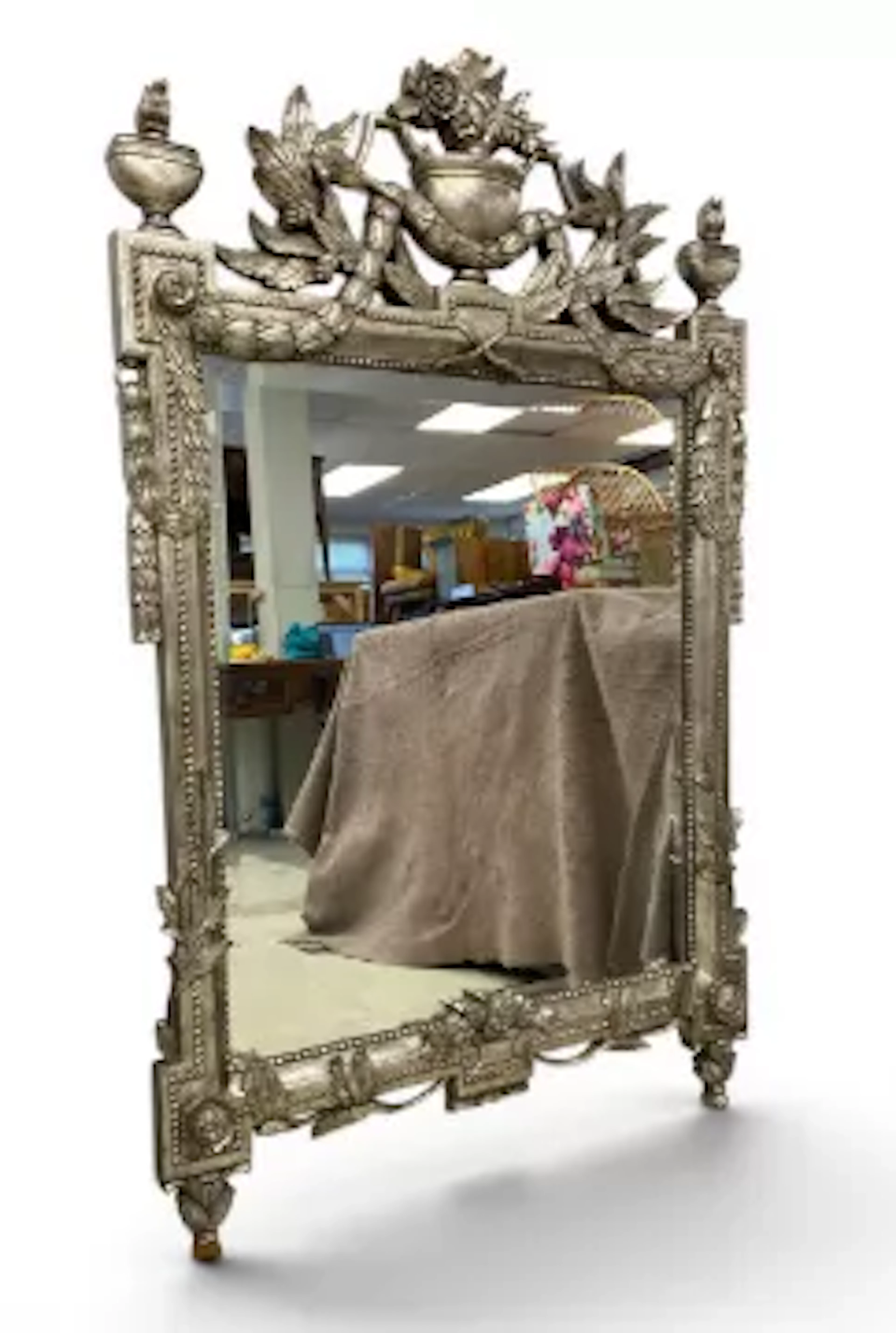 A vintage Empire style wall mirror having an elaborate openwork urn