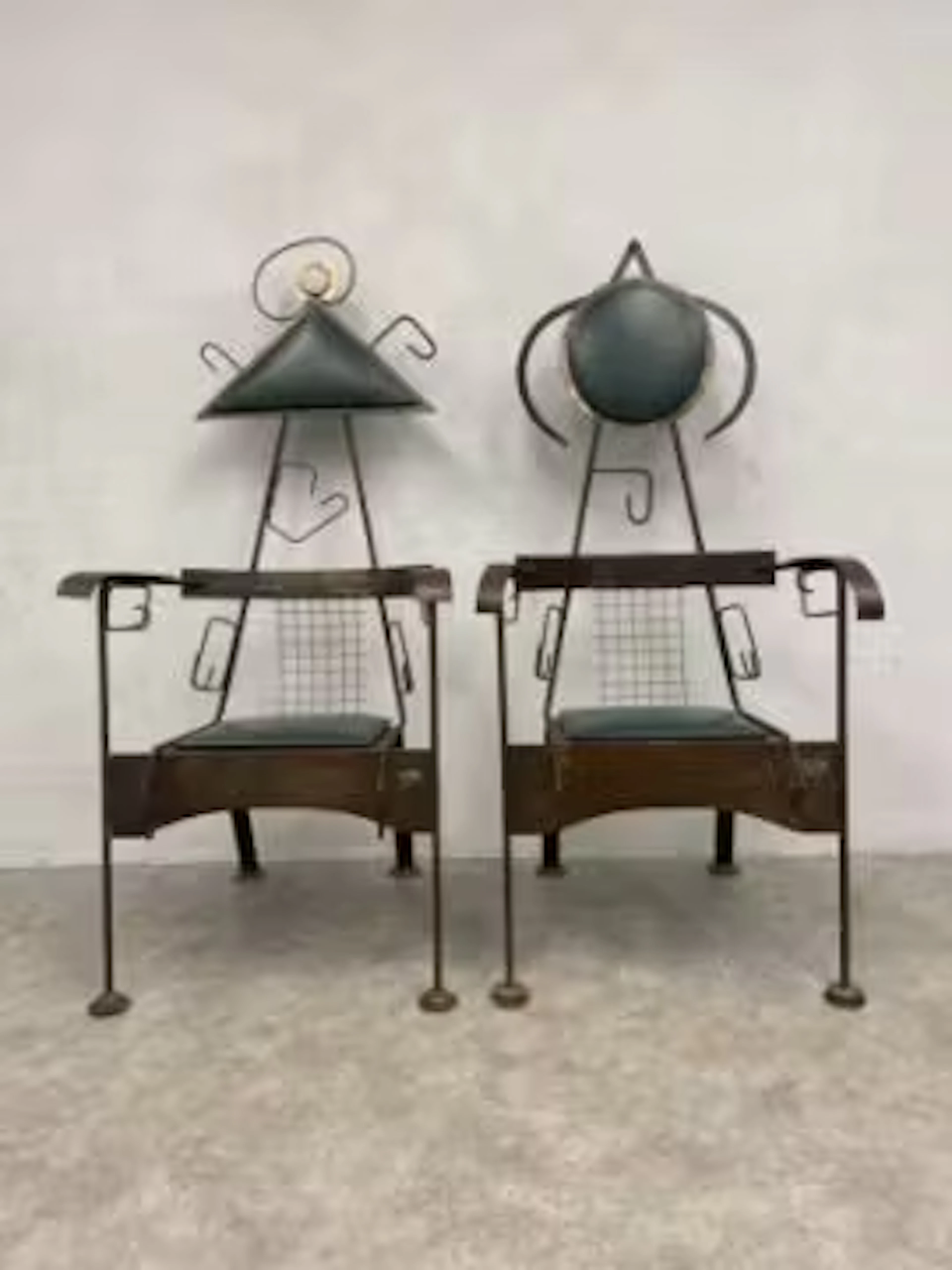 A pair of 1960's vintage metal and leather upholstered armchairs