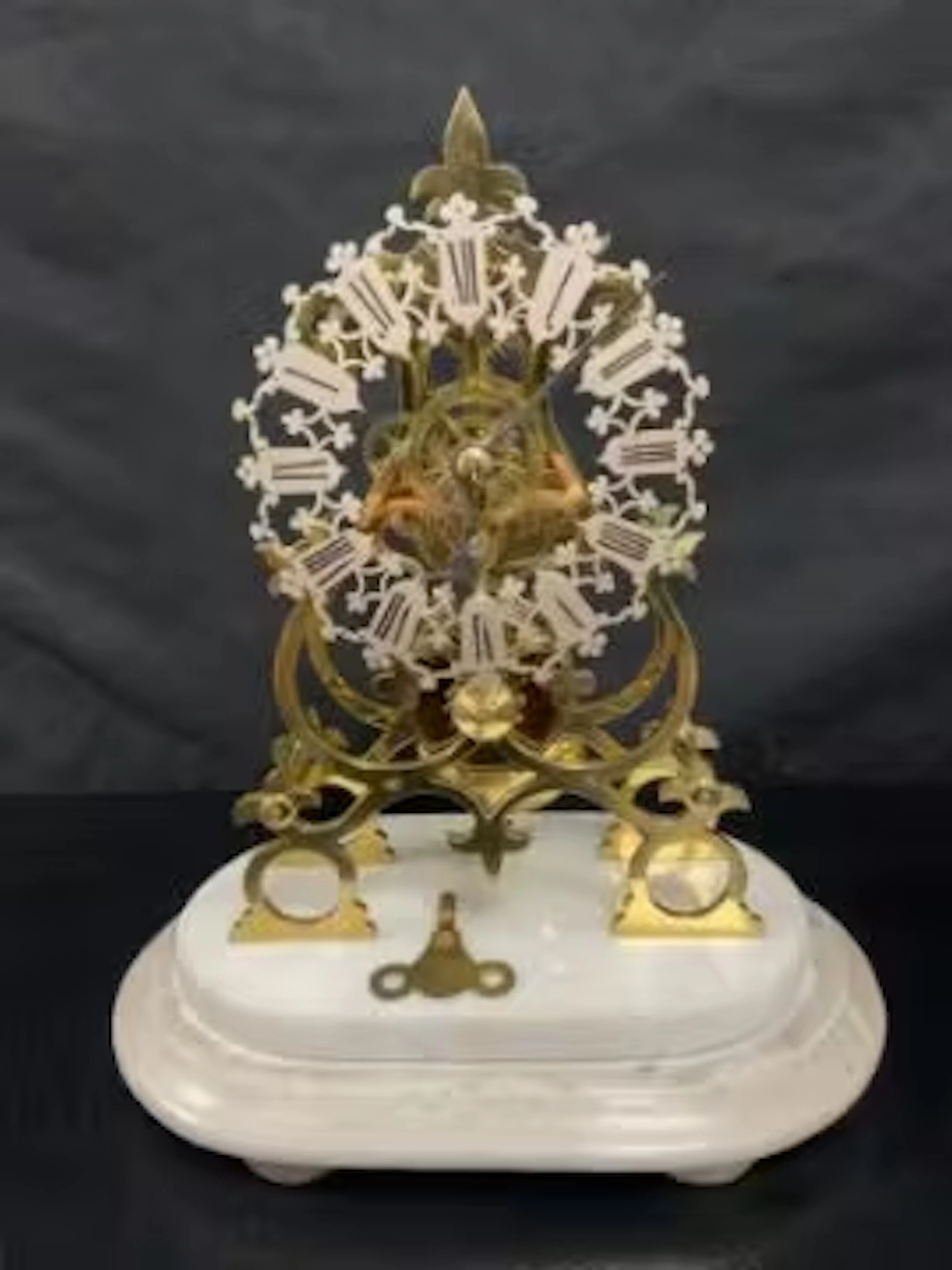 A late 19th century brass skeleton clock with chain driven fusee movement