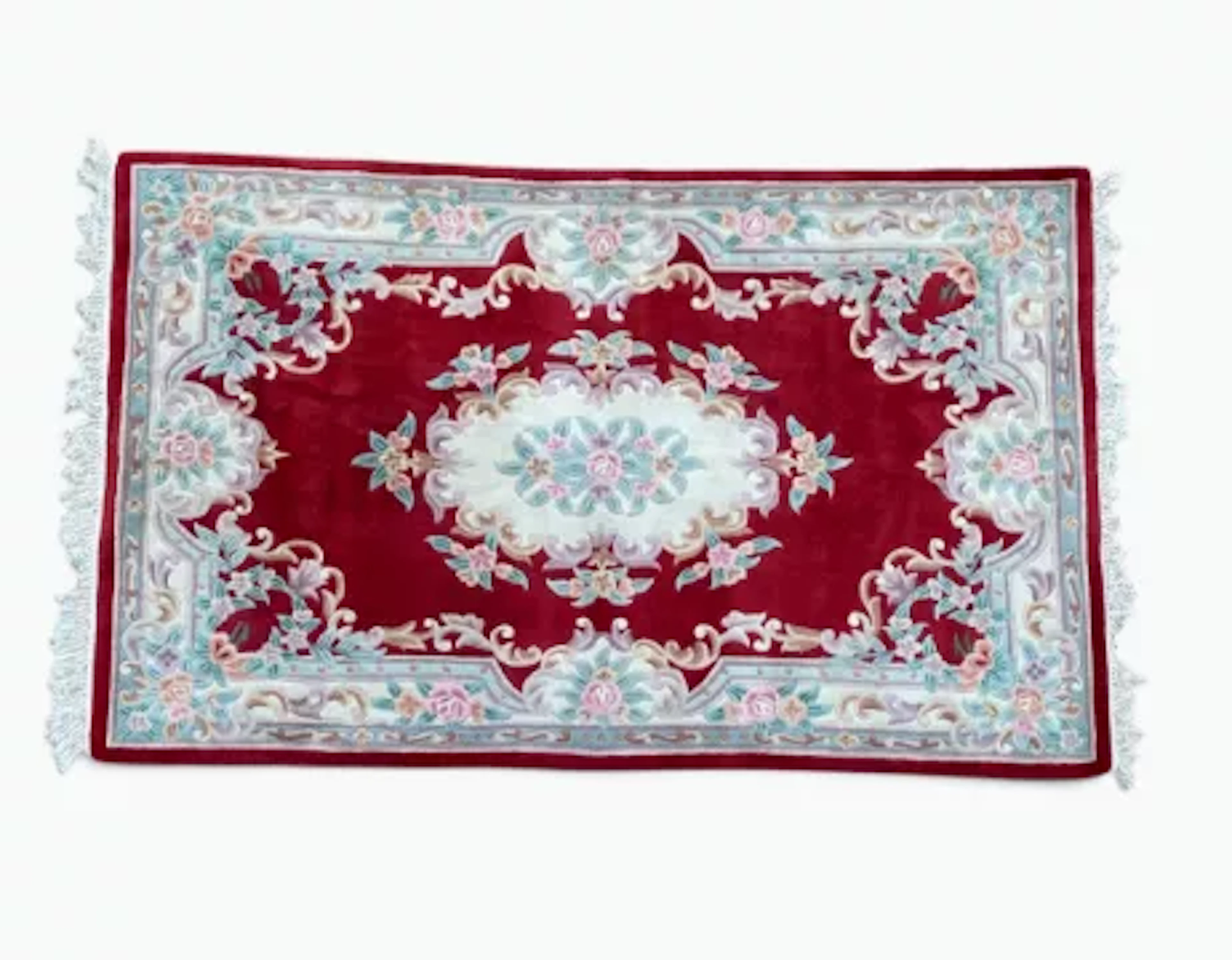 A Chinese Aubusson style woollen carpet with central foliate medallion