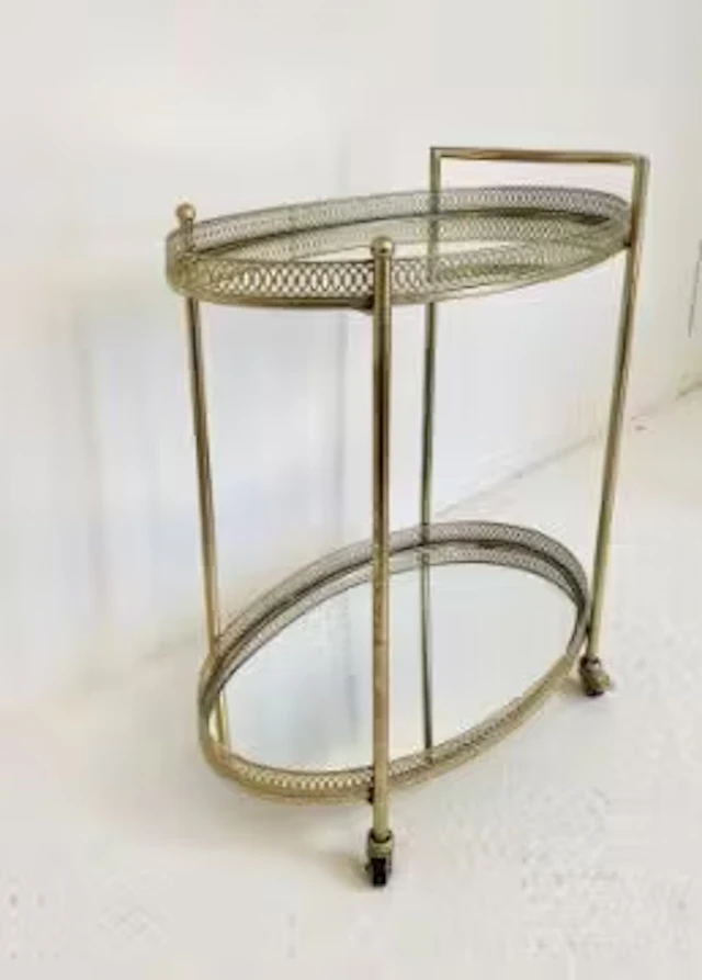 An Art Deco style drink's trolley in a silvered metal frame with pierced
