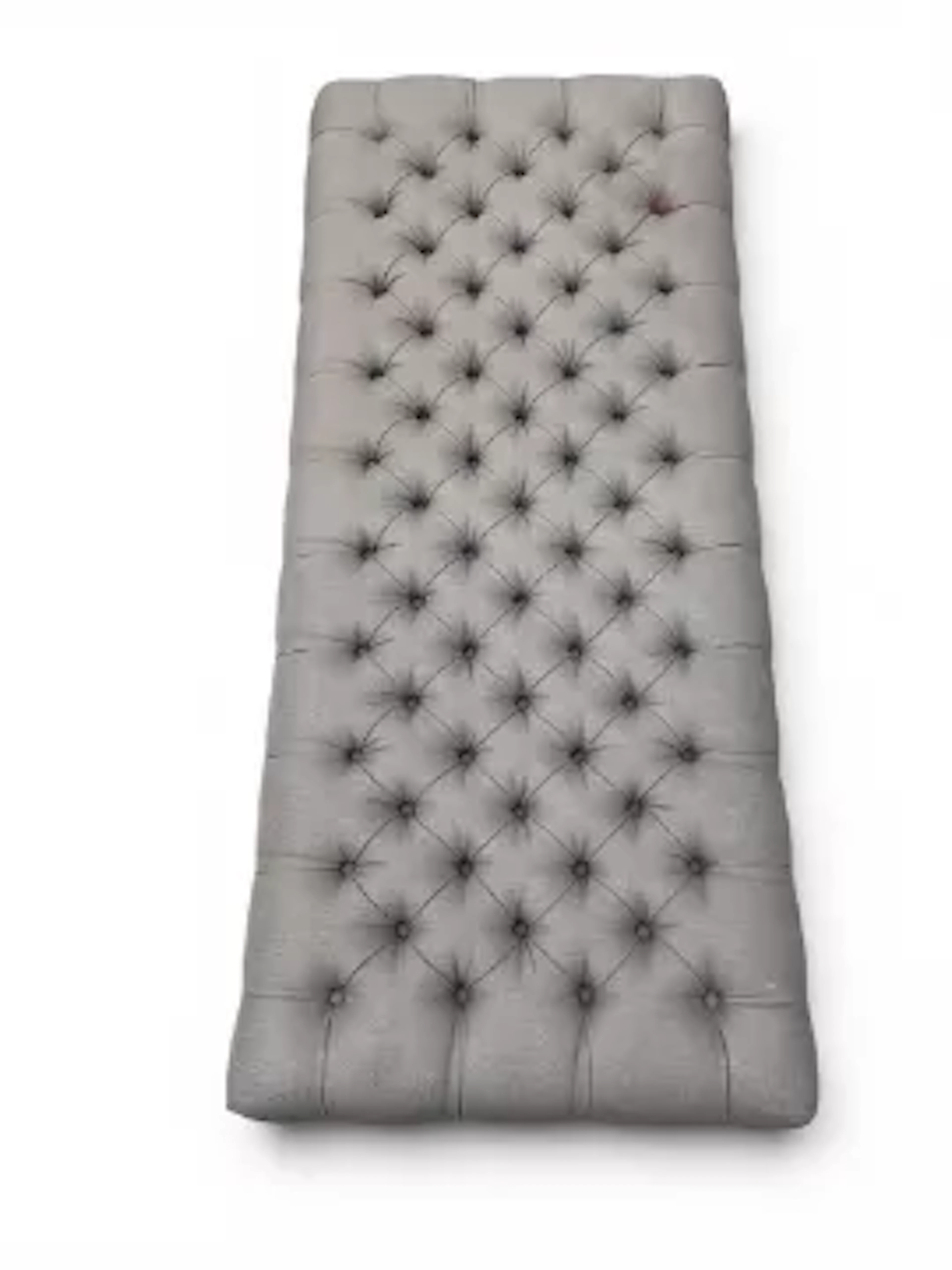 A contemporary Roche Bobois footstool or hearth stool in deep buttoned