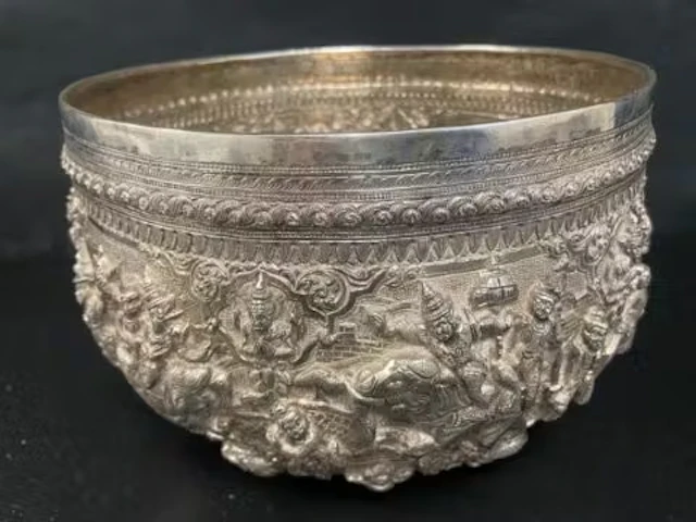 A large antique Burmese silver bowl richly embossed and chased with