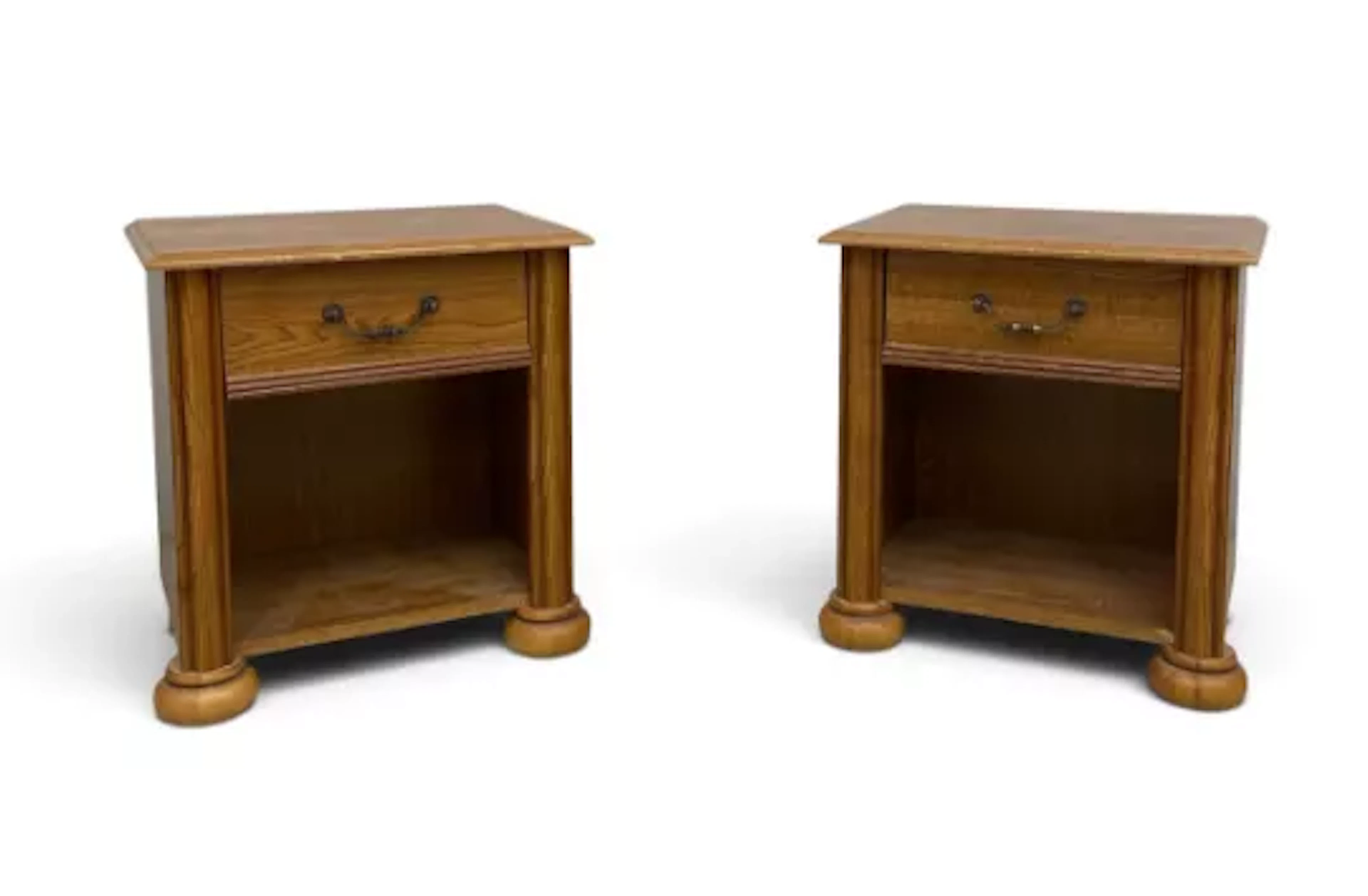 A pair of contemporary oak bedside table cabinets each with a single