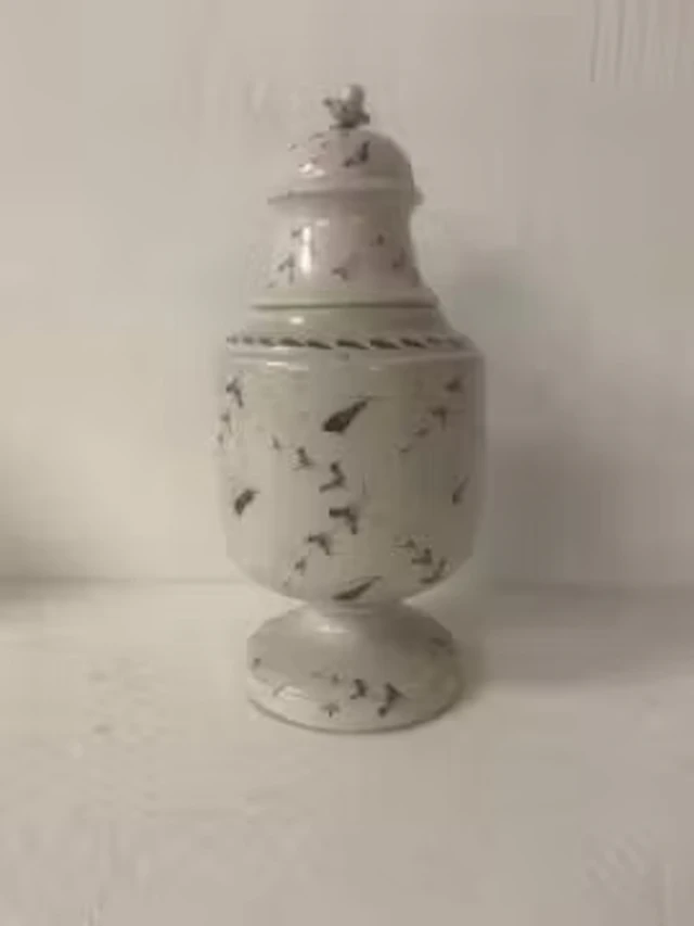 A 19th century lidded porcelain urn having a cup and cover finial