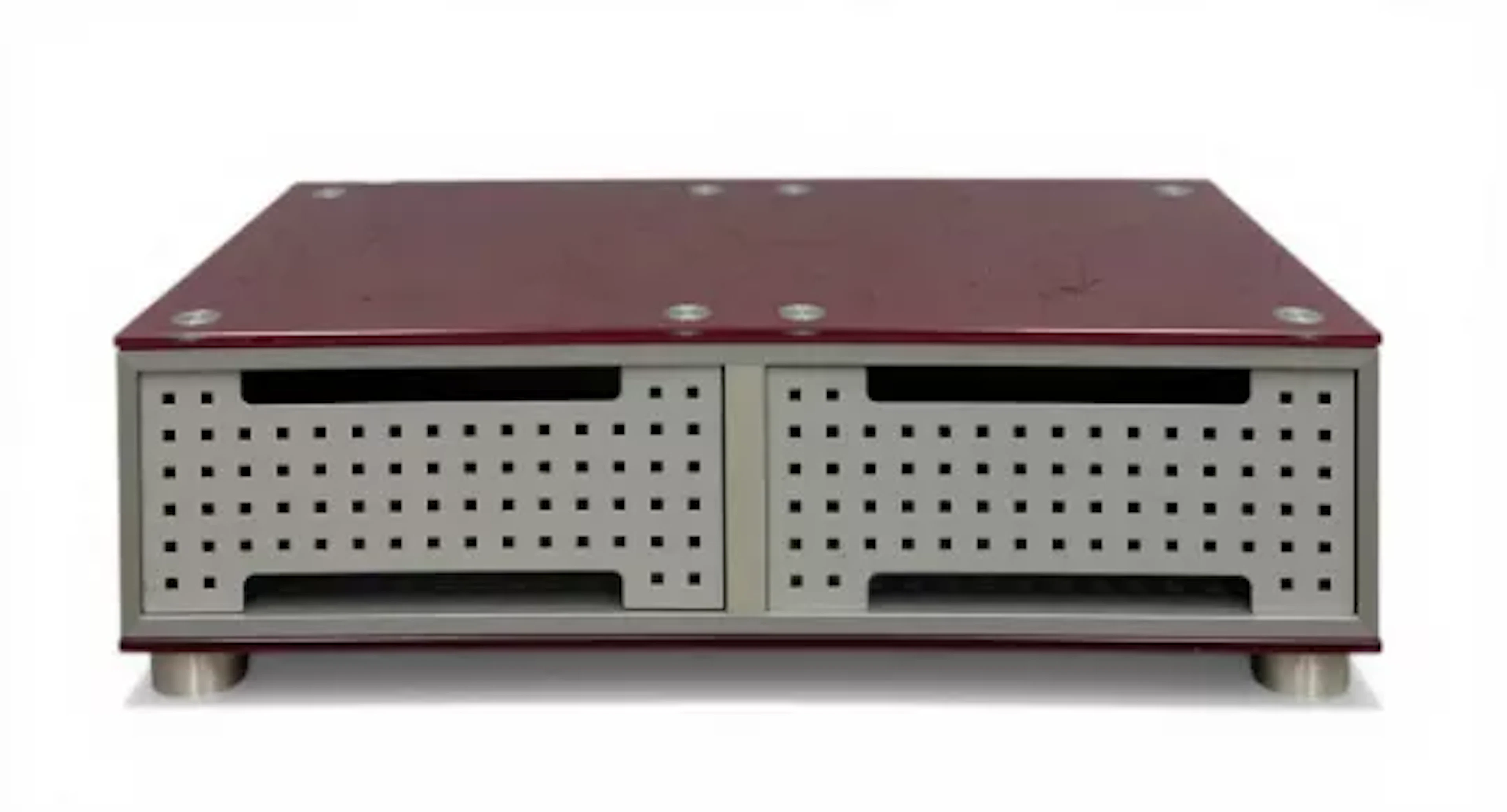 A contemporary coffee table having a red glass top over two recesses
