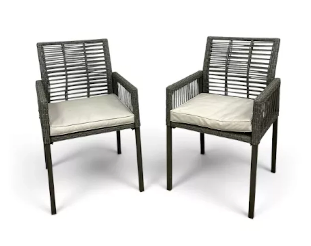 A contemporary pair of wicker armchairs, slatted backs with drop-in