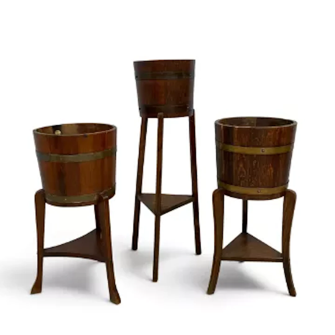 Three early 20th century oak coopered jardinere stands on tripod bases