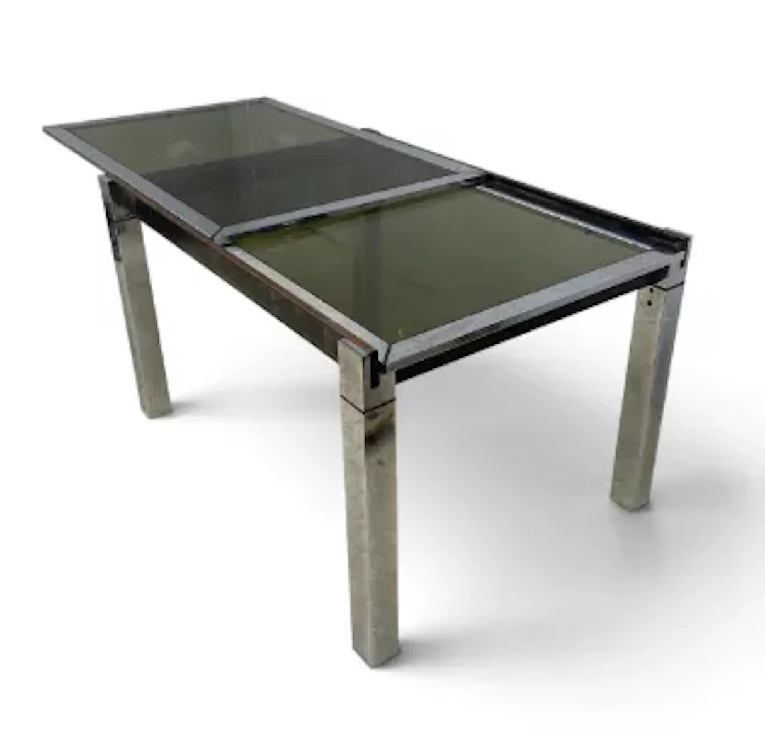 A C.1970 dining table with extending chromed metal base with smoked