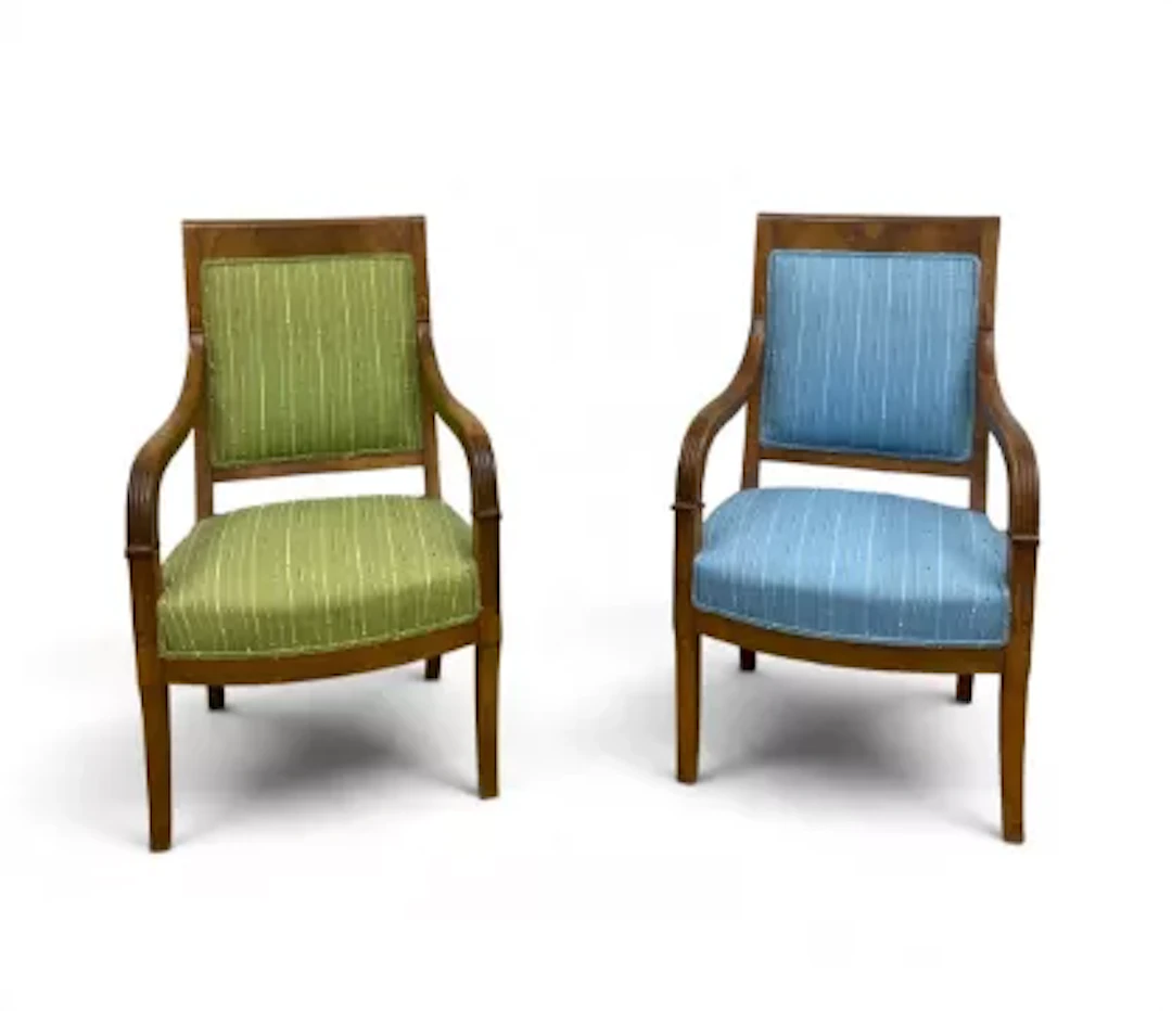 A pair of 19th century Empire style flame mahogany elbow armchairs