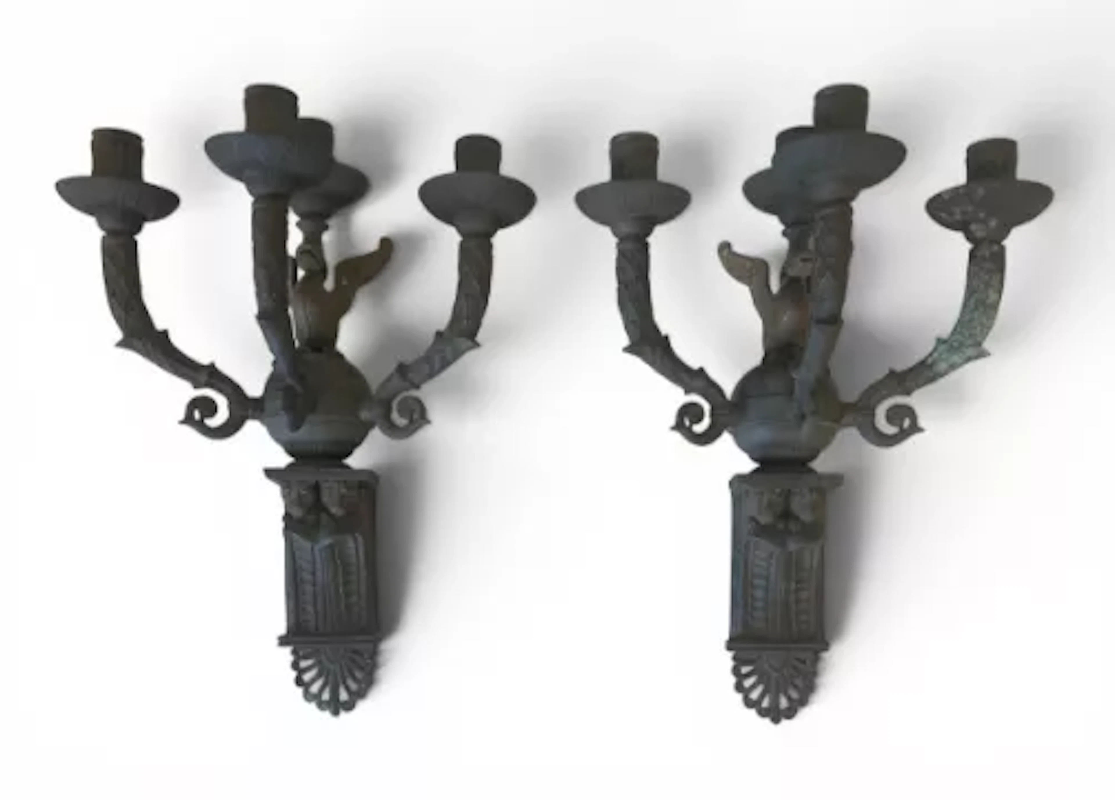 A pair of Gothic style four-branch cast iron wall sconces each with
