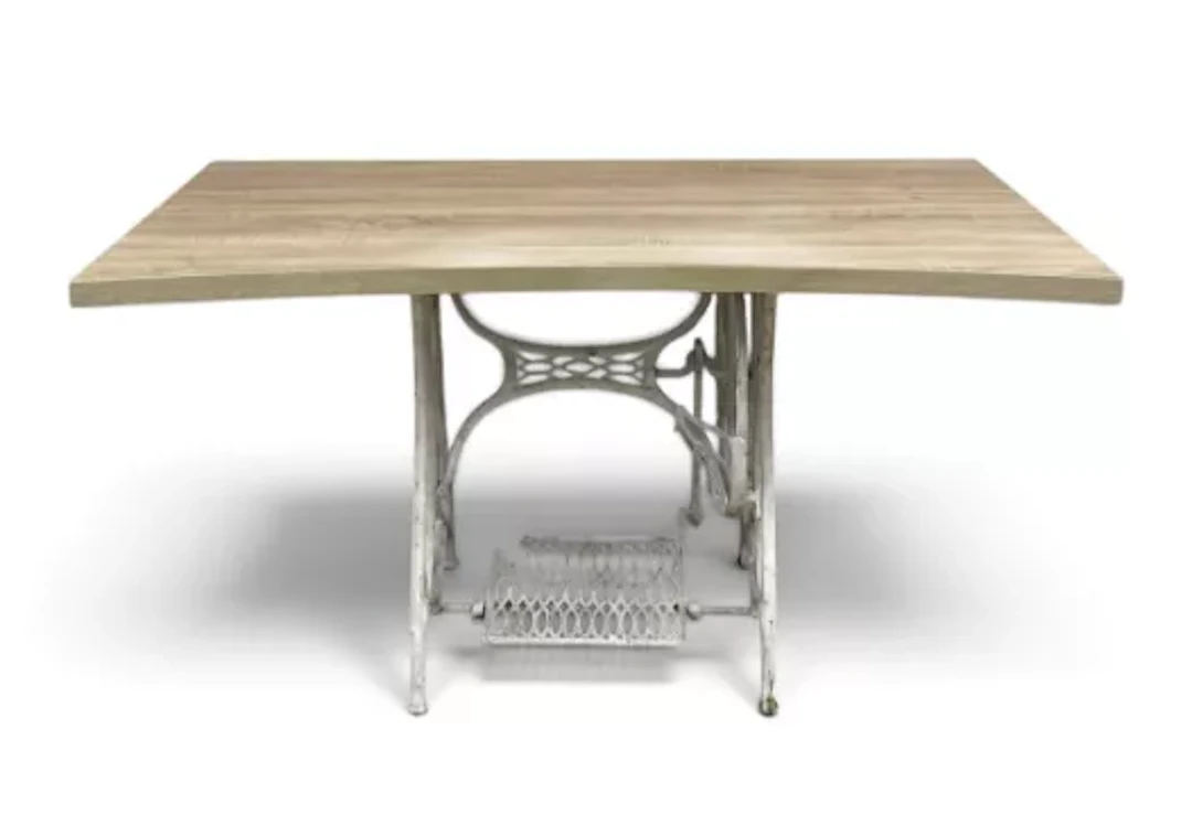 A writing or console table with a vintage wrought iron sewing table
