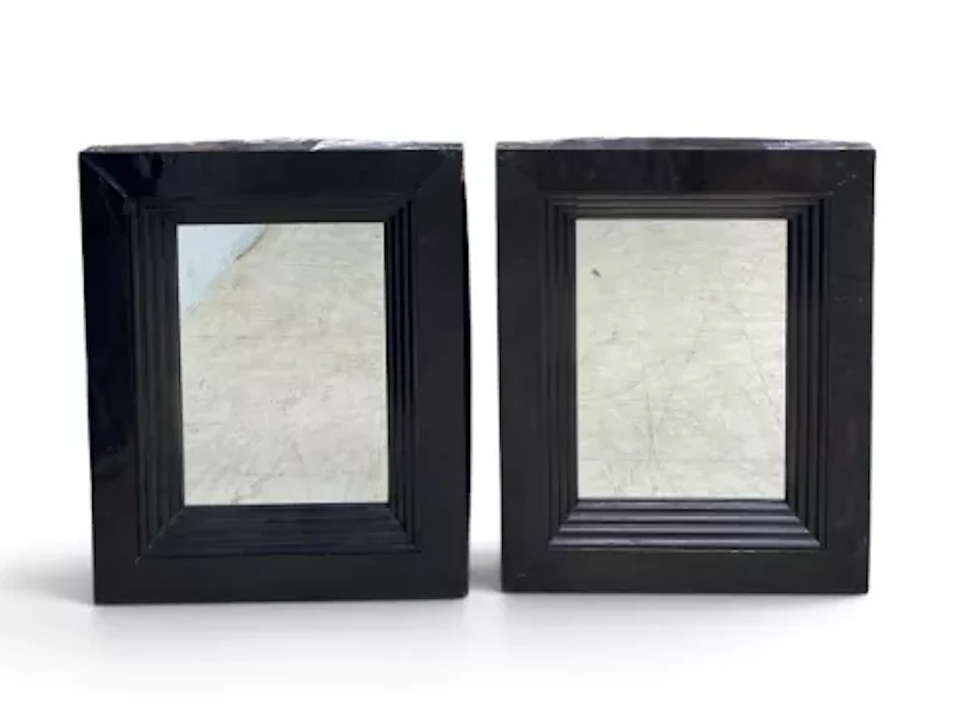 A pair of contemporary wall mirrors with stepped lacquered frames.
