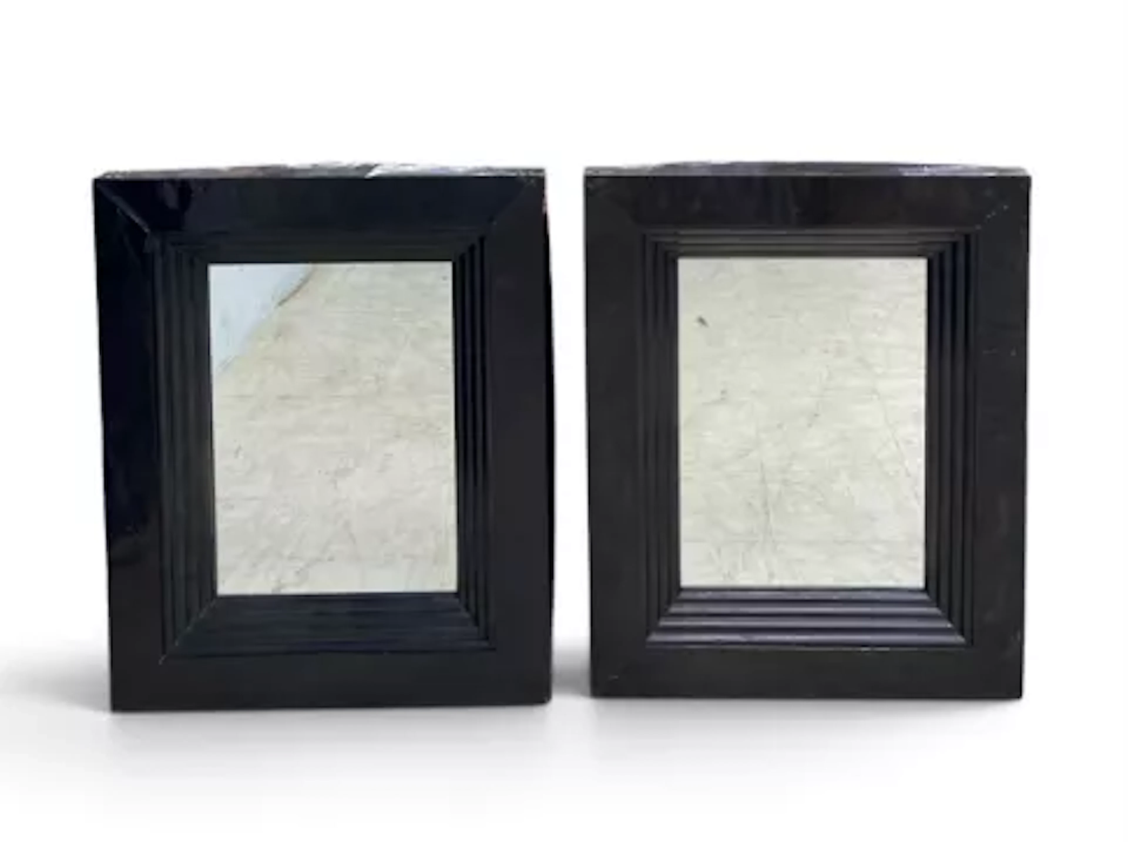 A pair of contemporary wall mirrors with stepped lacquered frames.