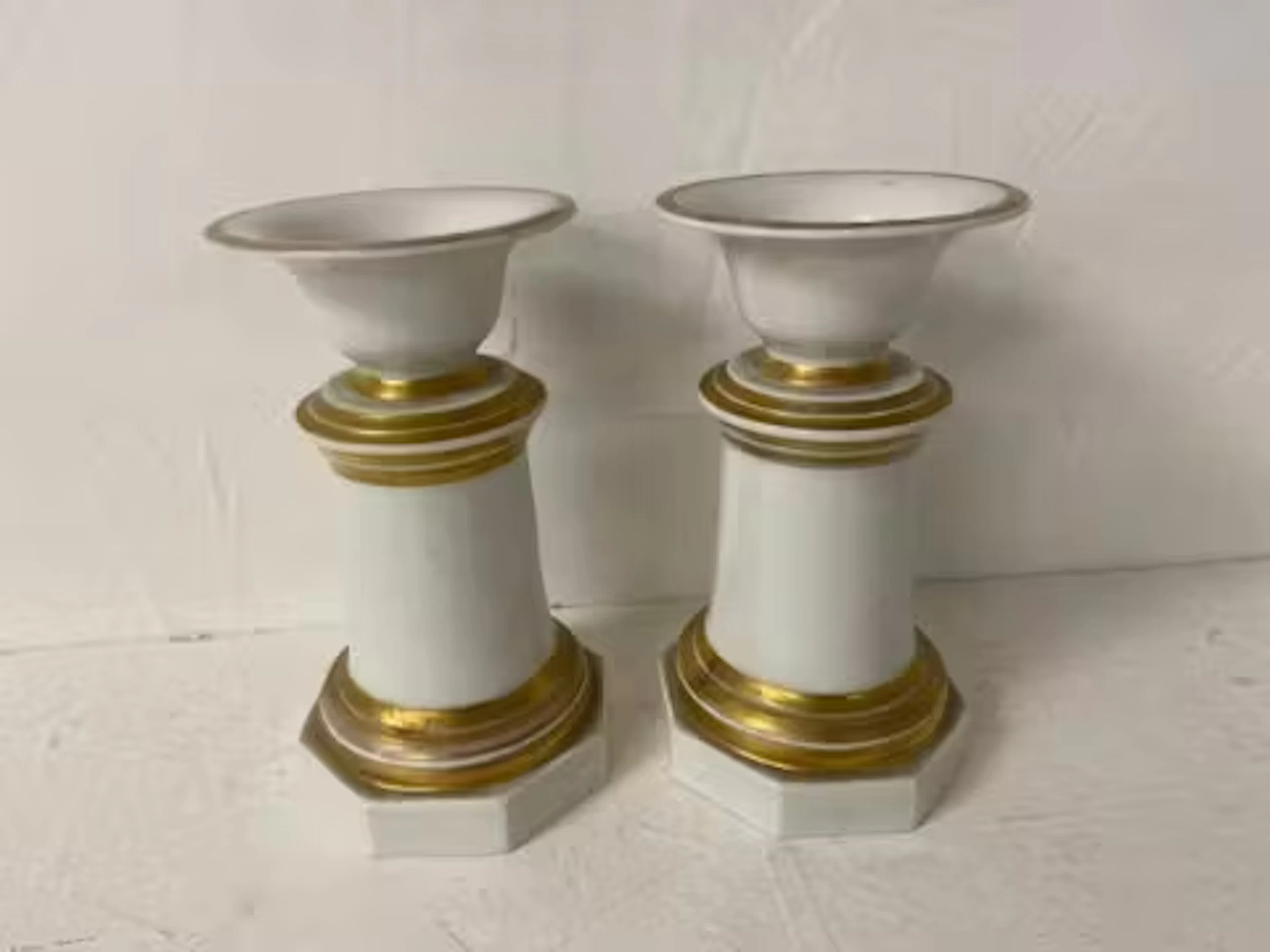 A pair of 19th century German KPM urns with gilt highlighted decoration