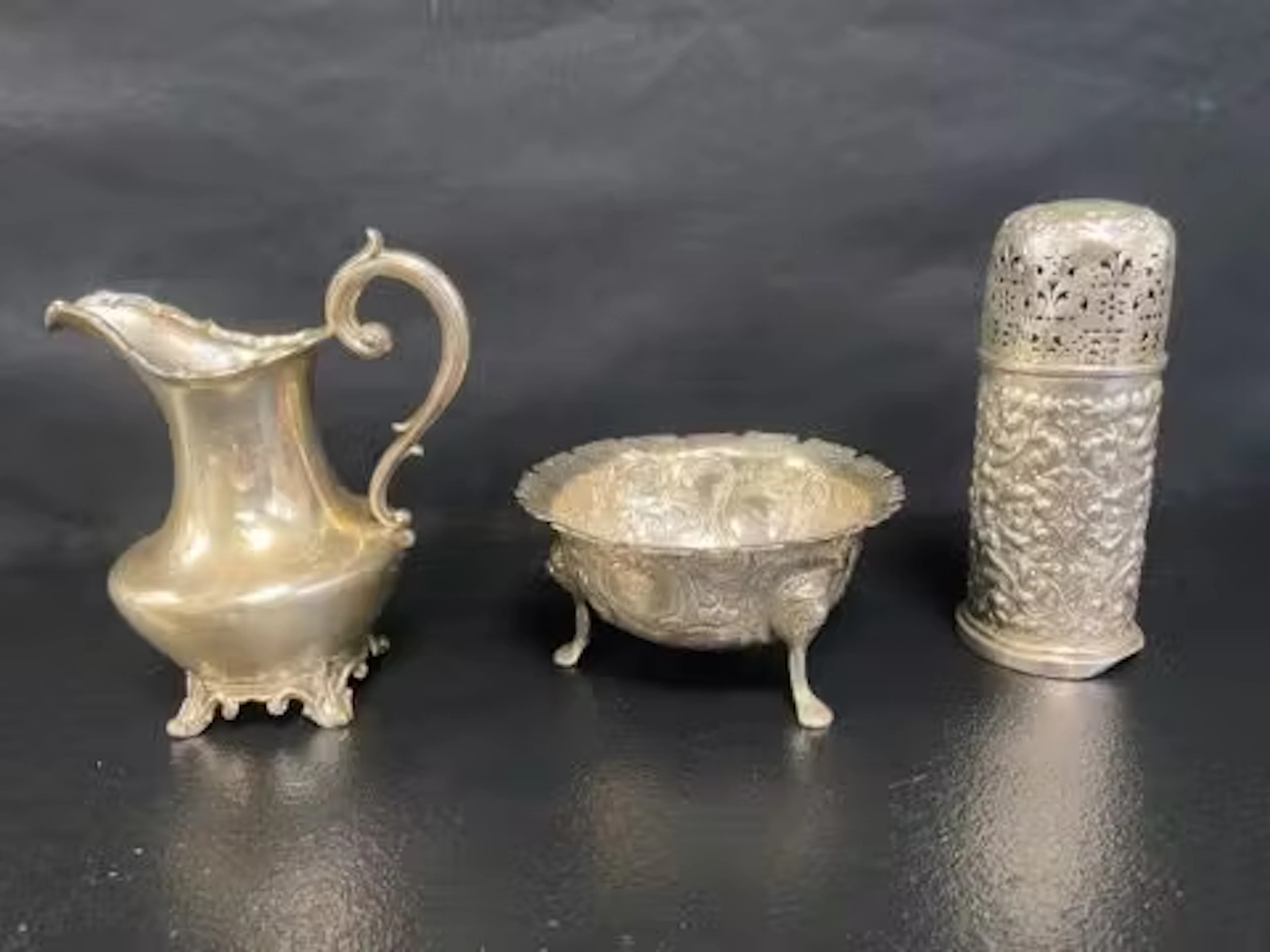 An Irish silver three footed bowl, Dublin 1877, an embossed silver