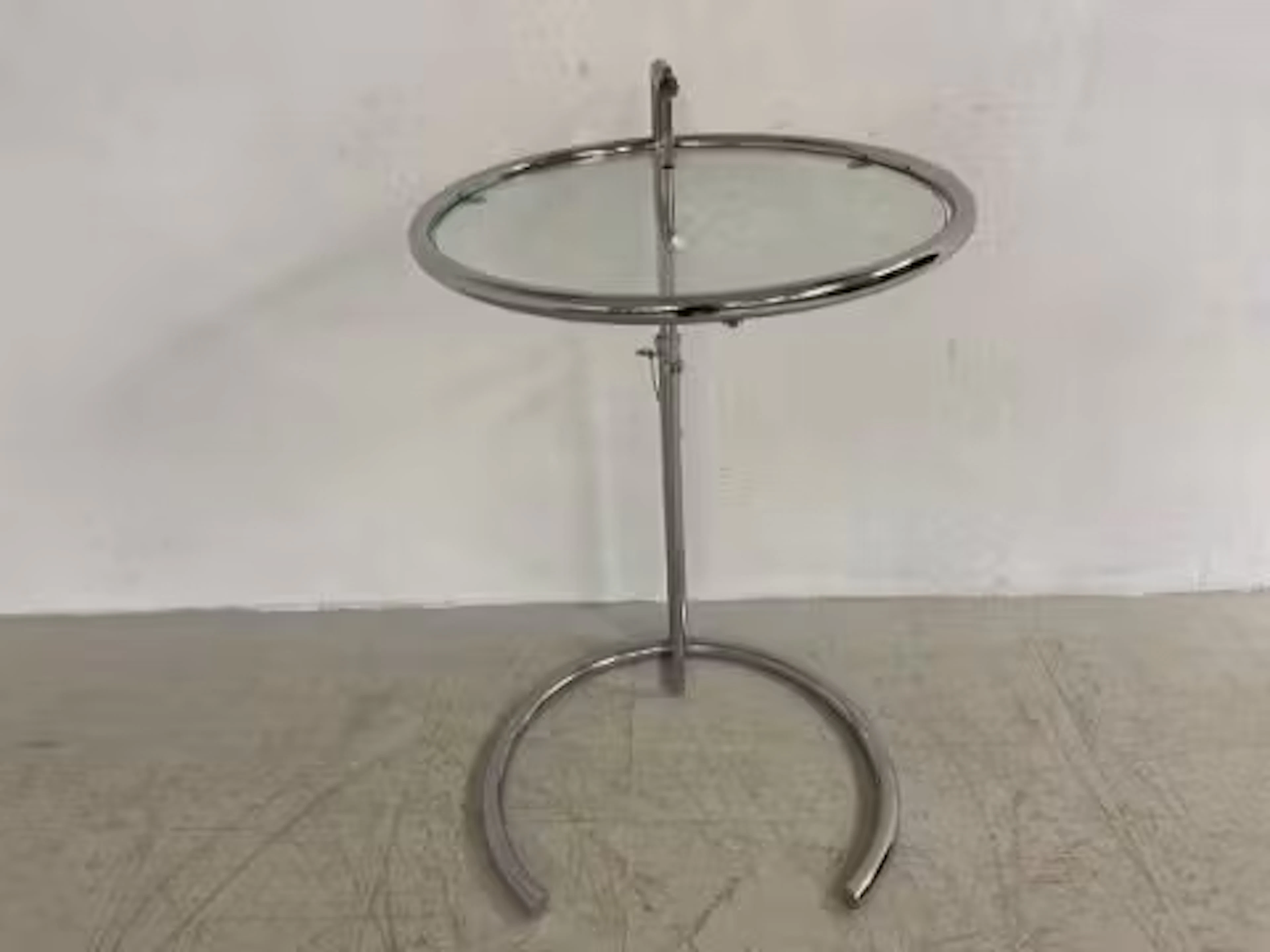 A vintage glass and tubular chrome side or occasional table with adjustable