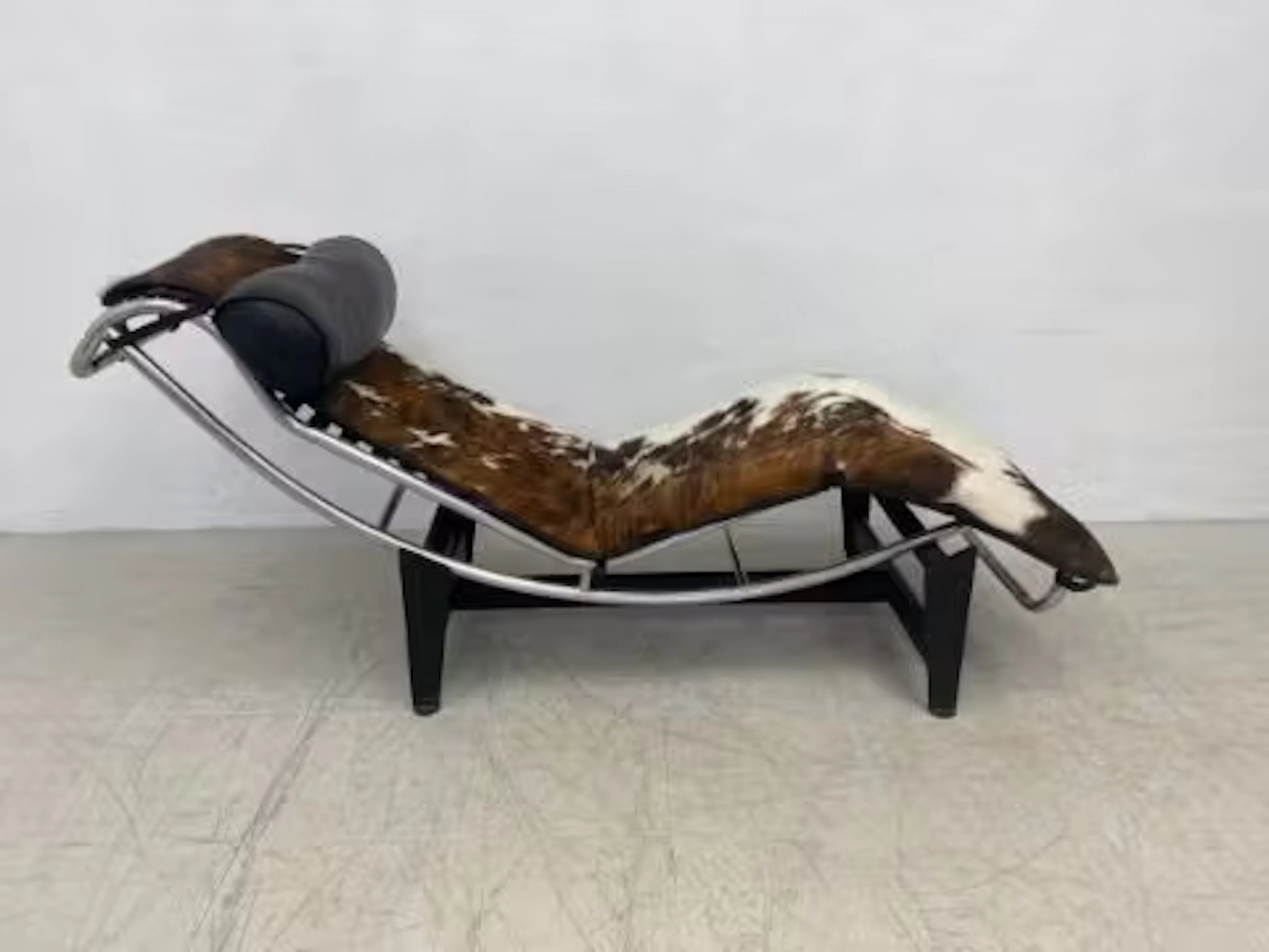 A Le Corbusier style LC4 chaise in leather and cowhide upholstery
