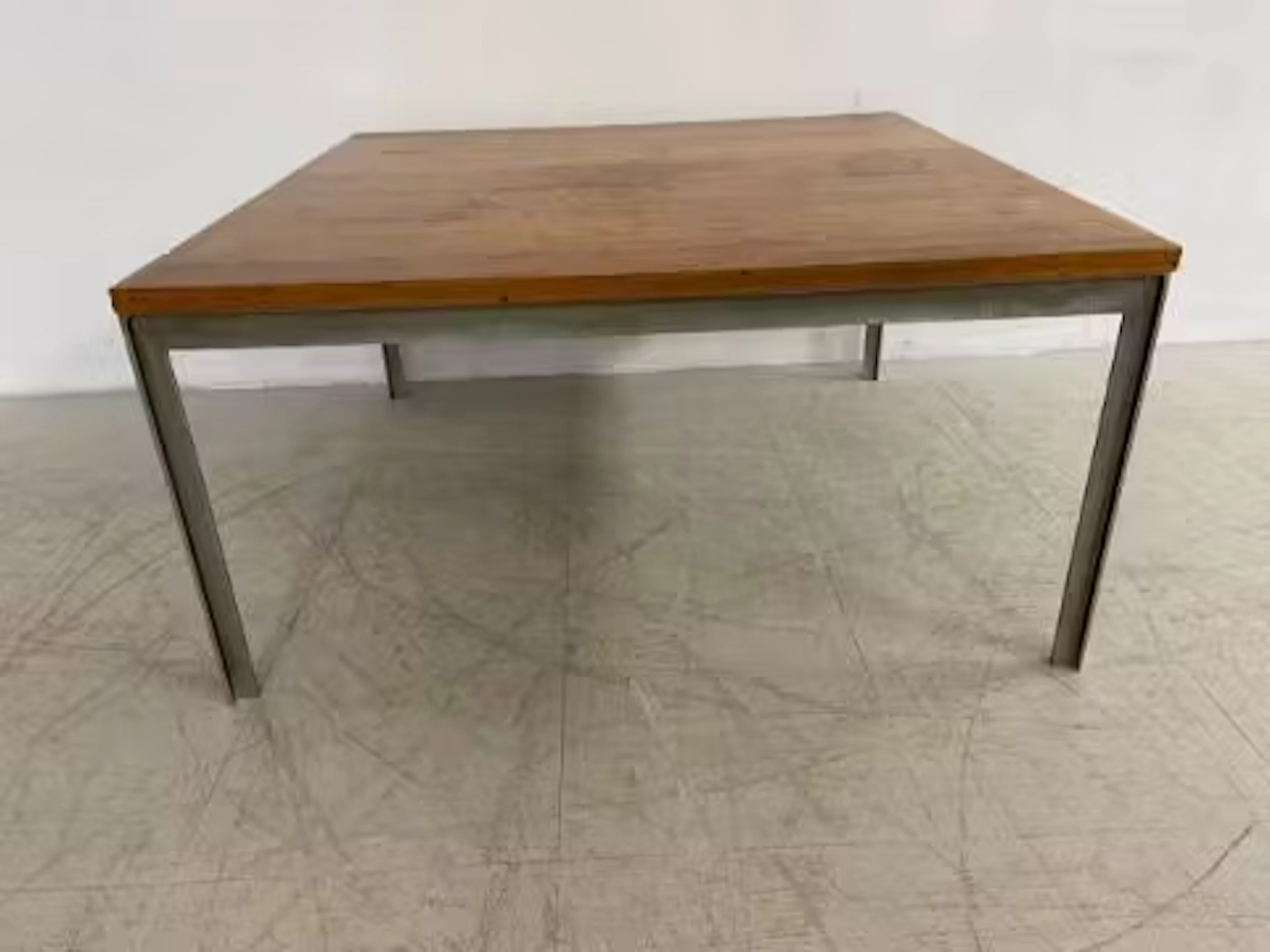 A mid-century coffee table in the style of Florence Knoll with square
