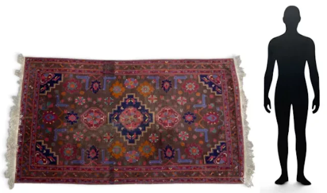 A hand knotted Kazak carpet with a central stepped lozenge medallion