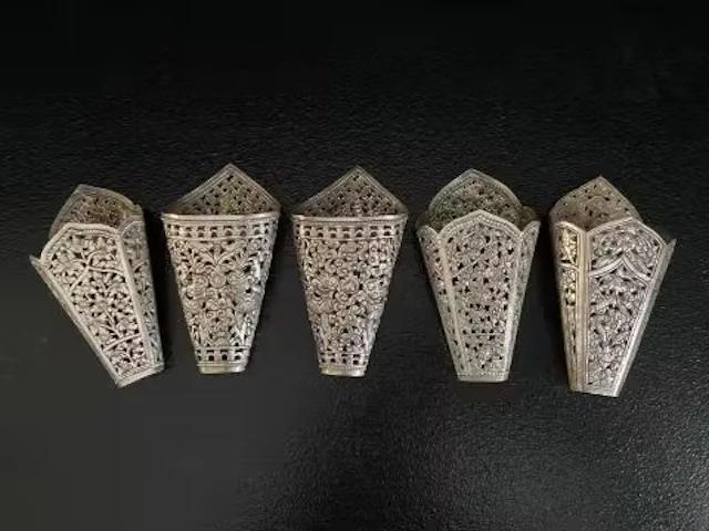 Three South East Asian silver betel leaf holders with all-over pierced