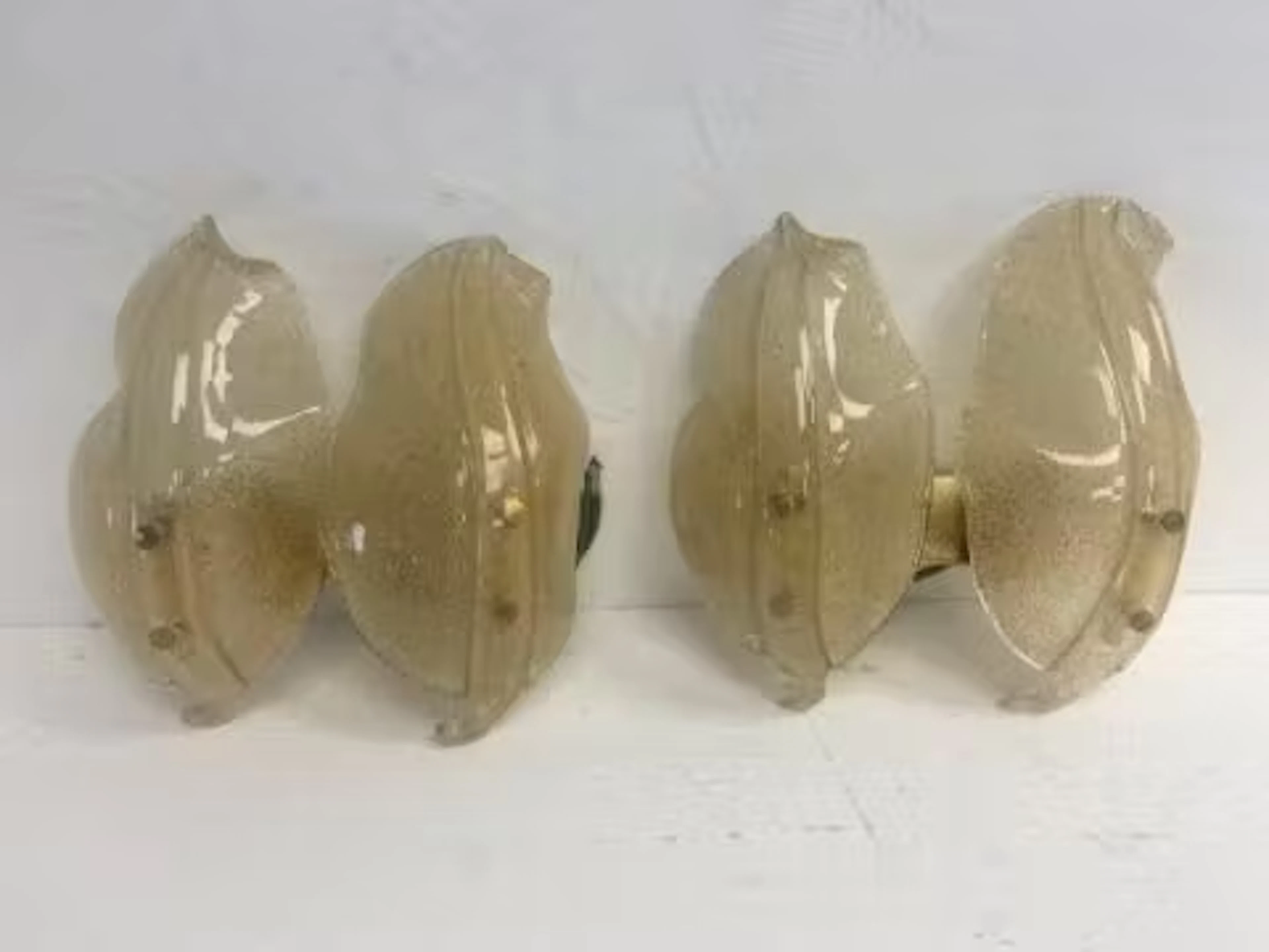 A pair of vintage brass and frosted Murano glass wall lights of leaf