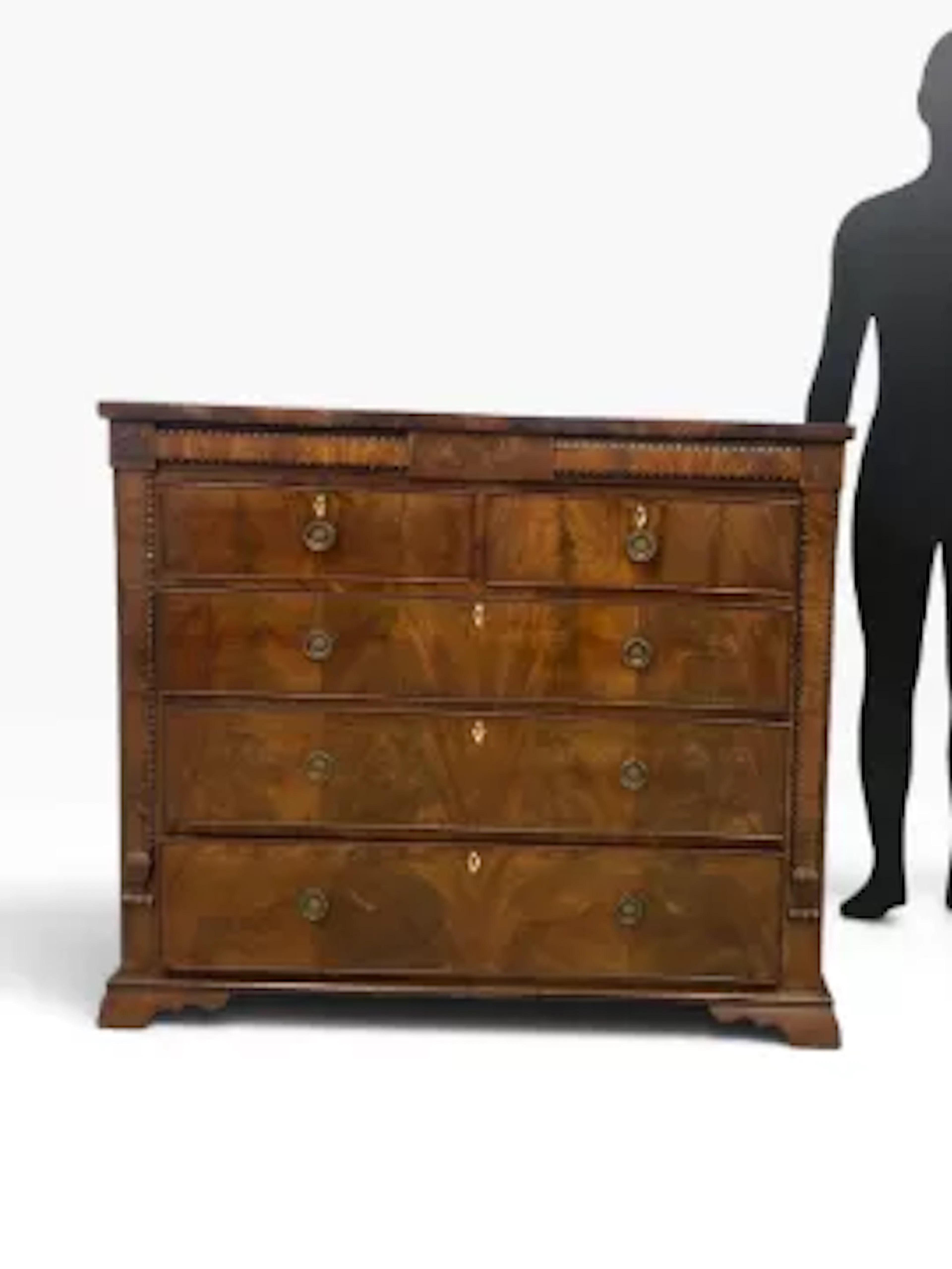 A 19th century flame mahogany chest of drawers with two secret frieze