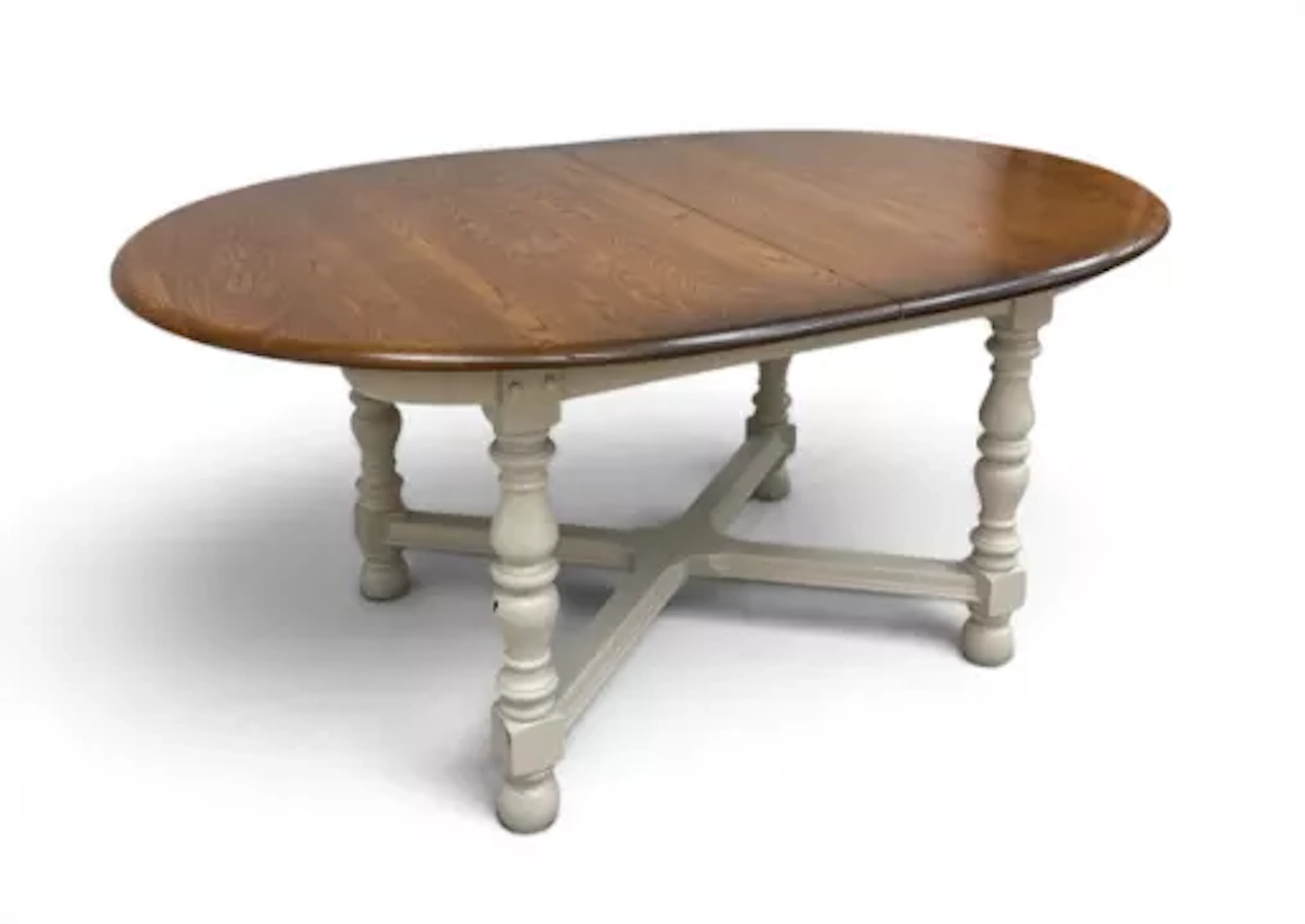 A vintage Ercol elm top dining table with integral butterfly leaf