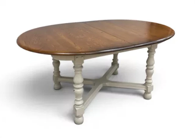 A vintage Ercol elm top dining table with integral butterfly leaf