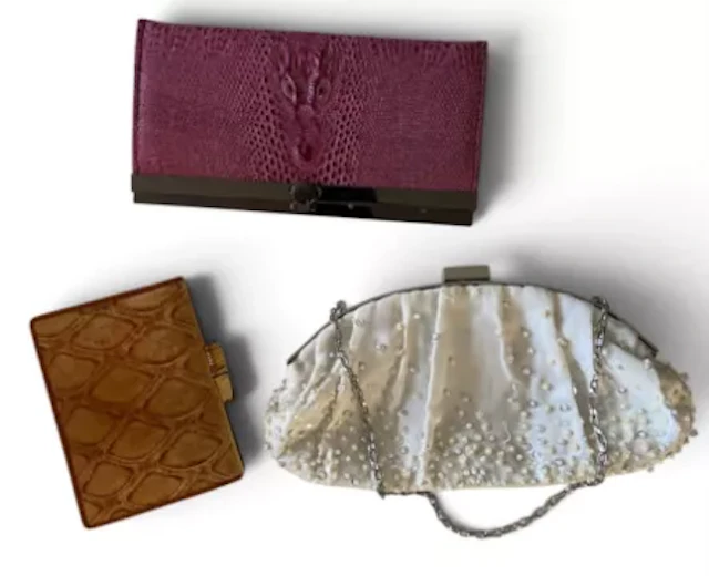 A collection of vintage handbags including; a pink clutch purse with