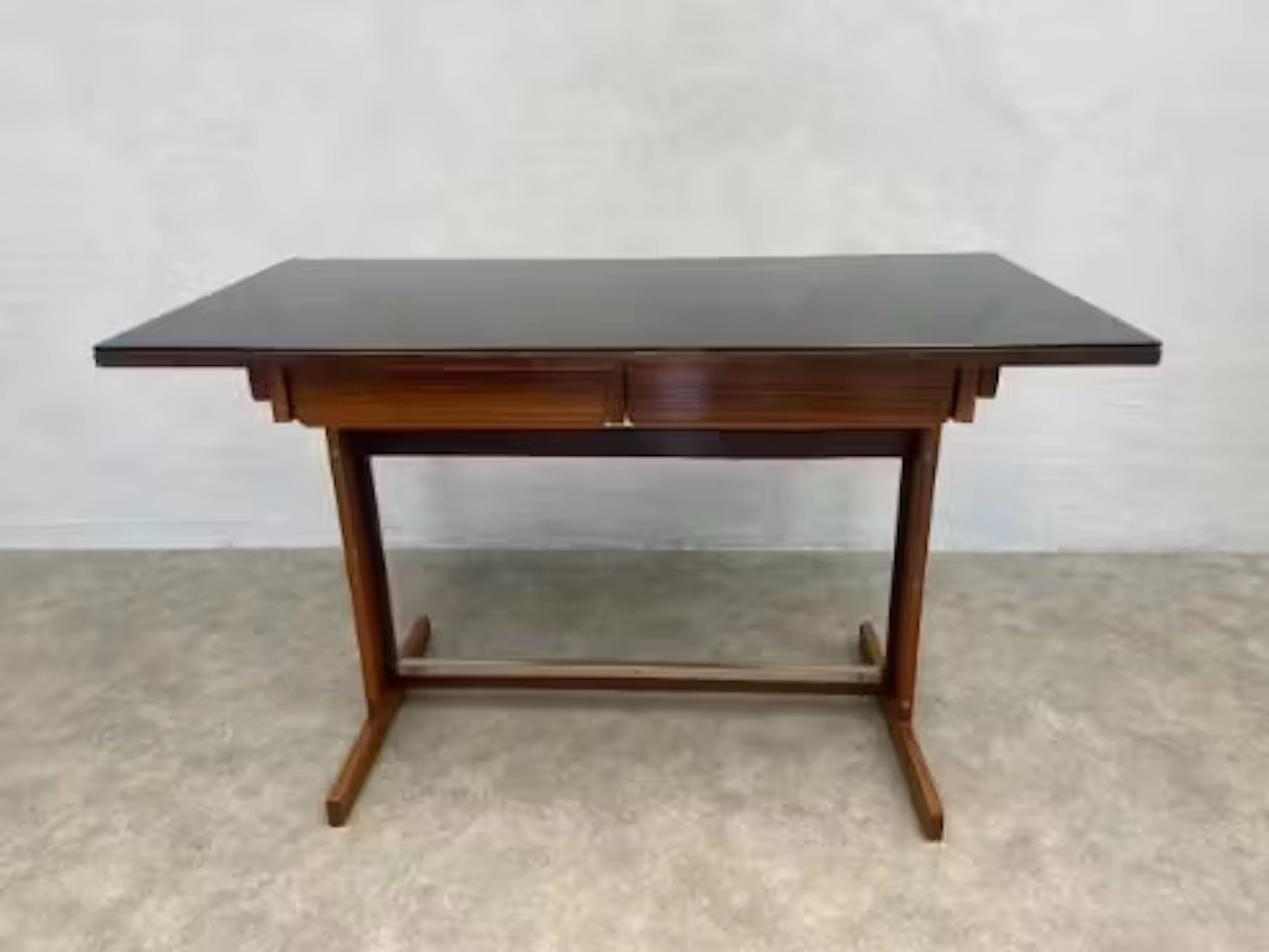 A mid century Cassina writing table with black plate glass top above