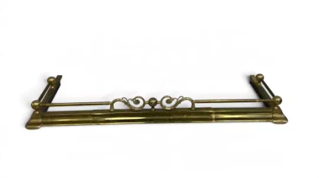 A late 19th century extending brass fireplace surround, ornate floral