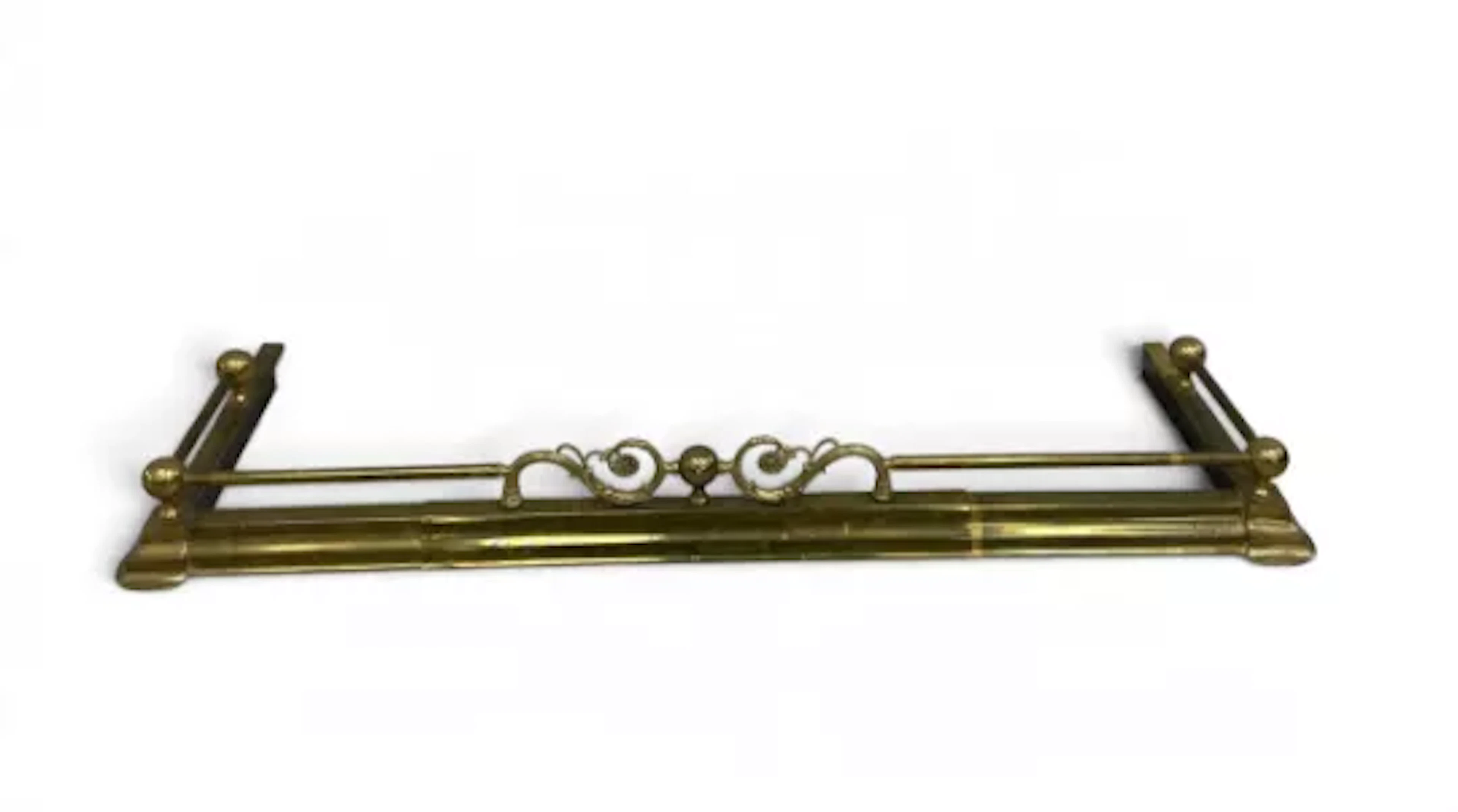 A late 19th century extending brass fireplace surround, ornate floral