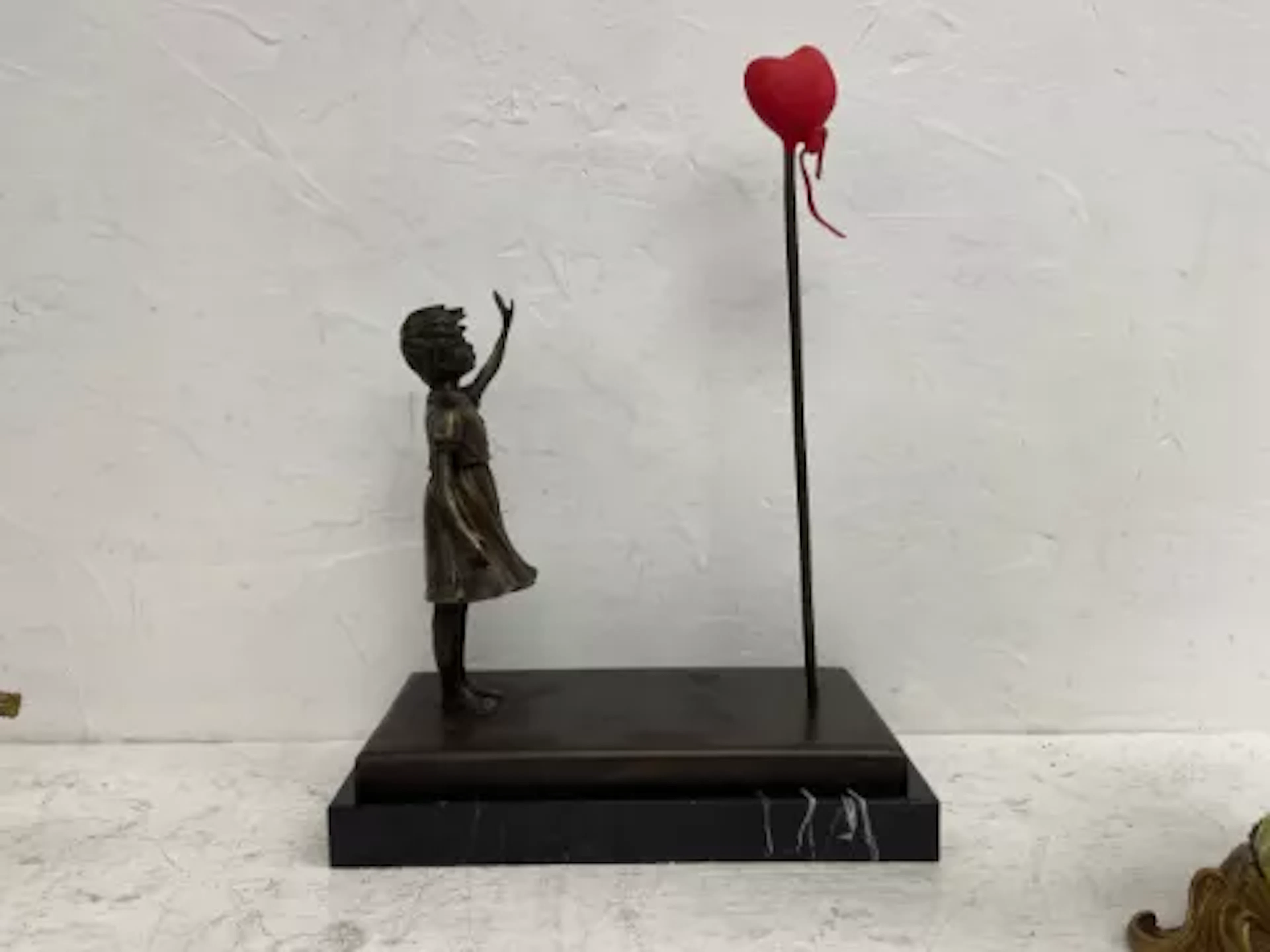 After Banksy (b.1973), a contemporary signed figural bronze titled