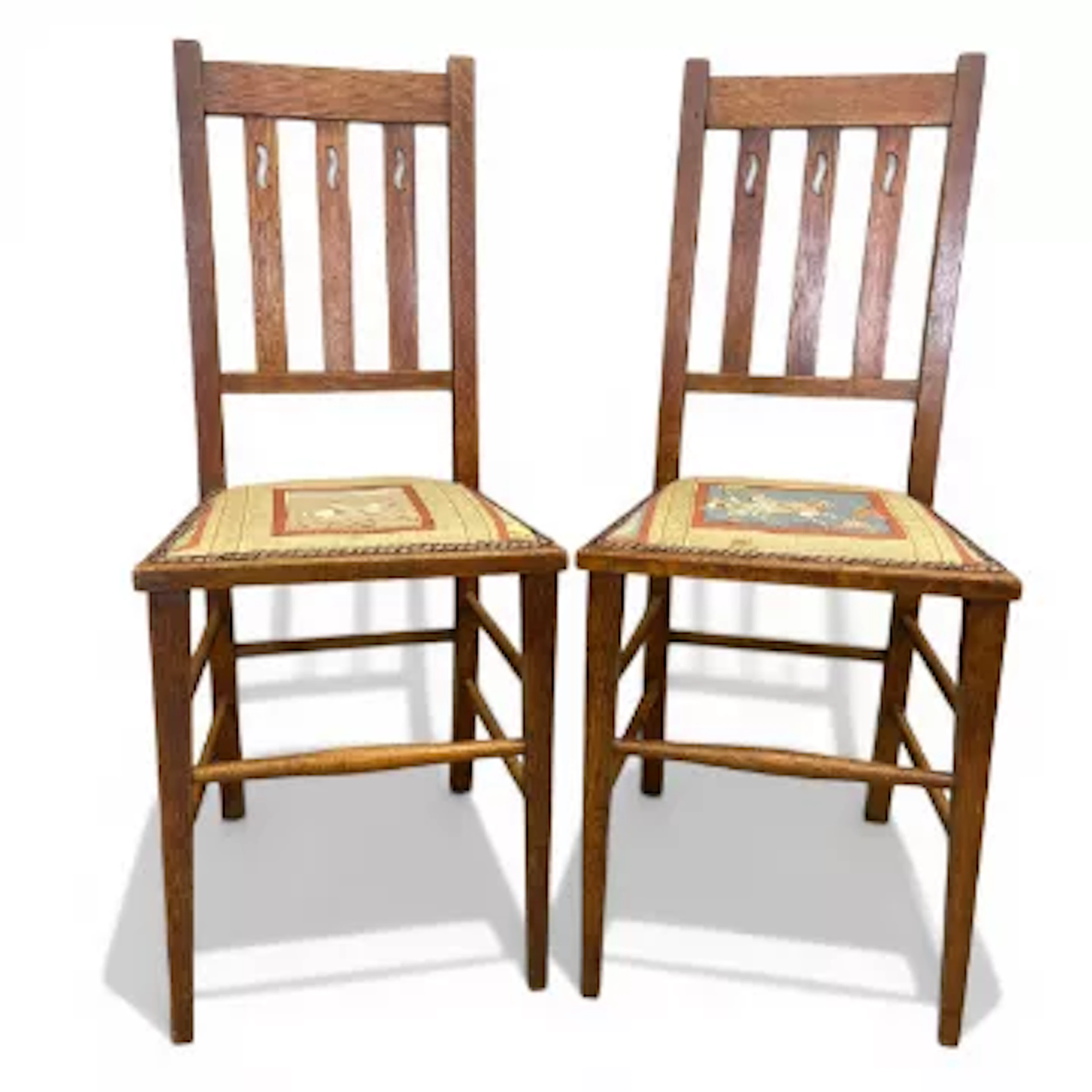 A pair of C.1900 Arts & Crafts oak side chairs with slatted openwork