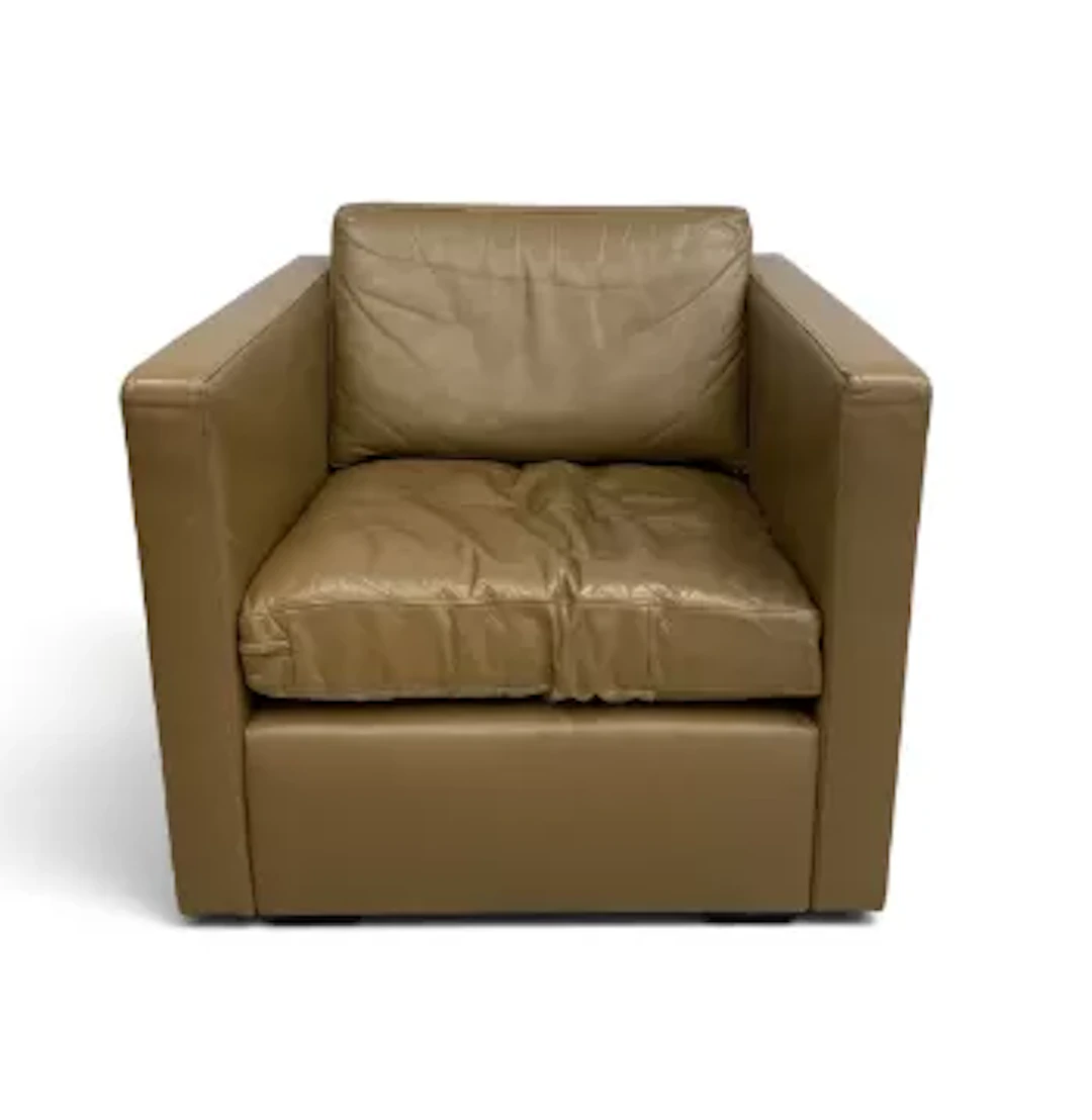 A vintage lounge armchair in leather upholstery. H 70cm x W 76cm x D 79cm.