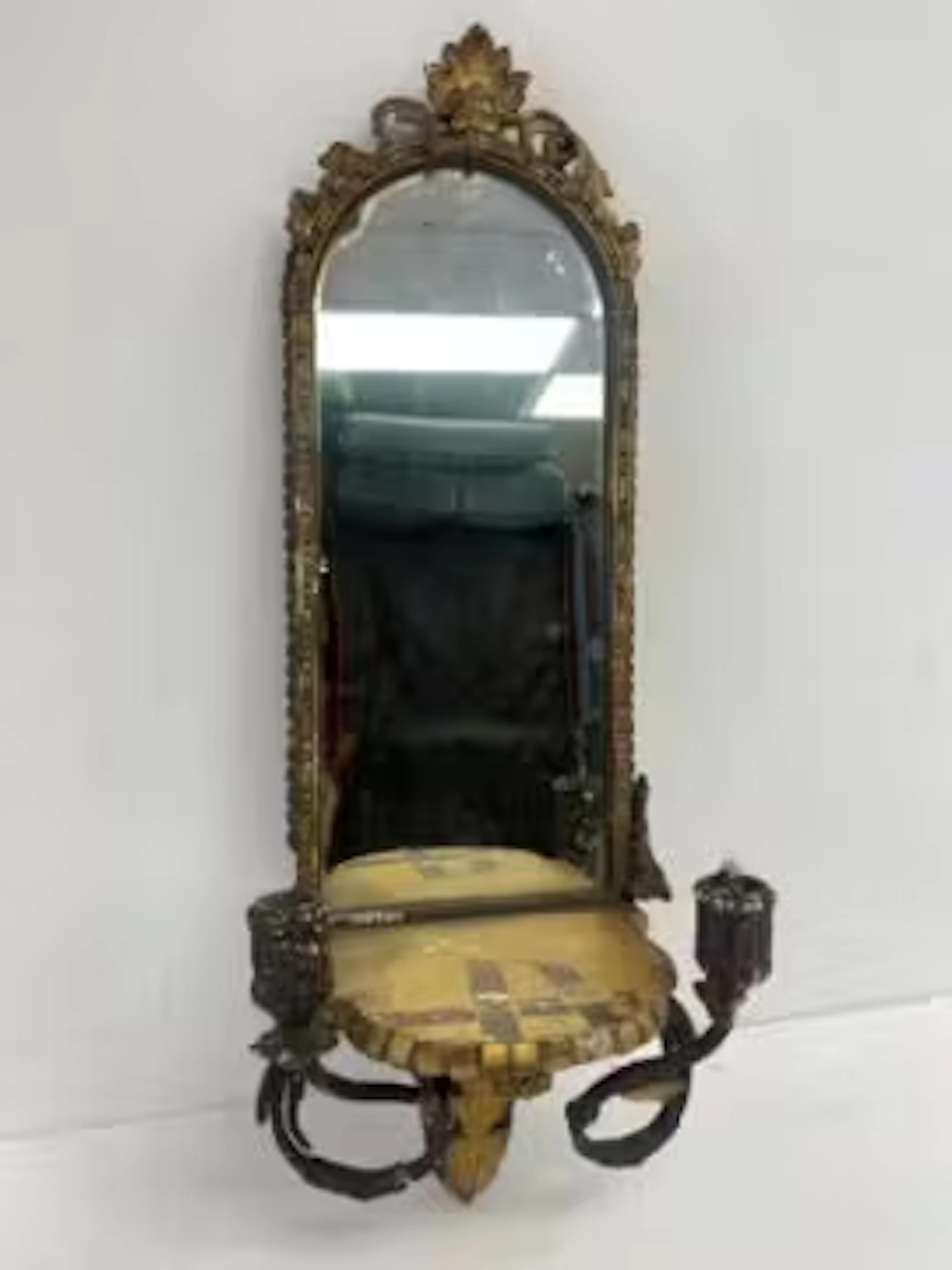 A small 19th century girandole wall mirror with twin sconces in a