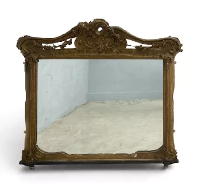 A 19th century giltwood and gesso overmantel mirror with foliate arched