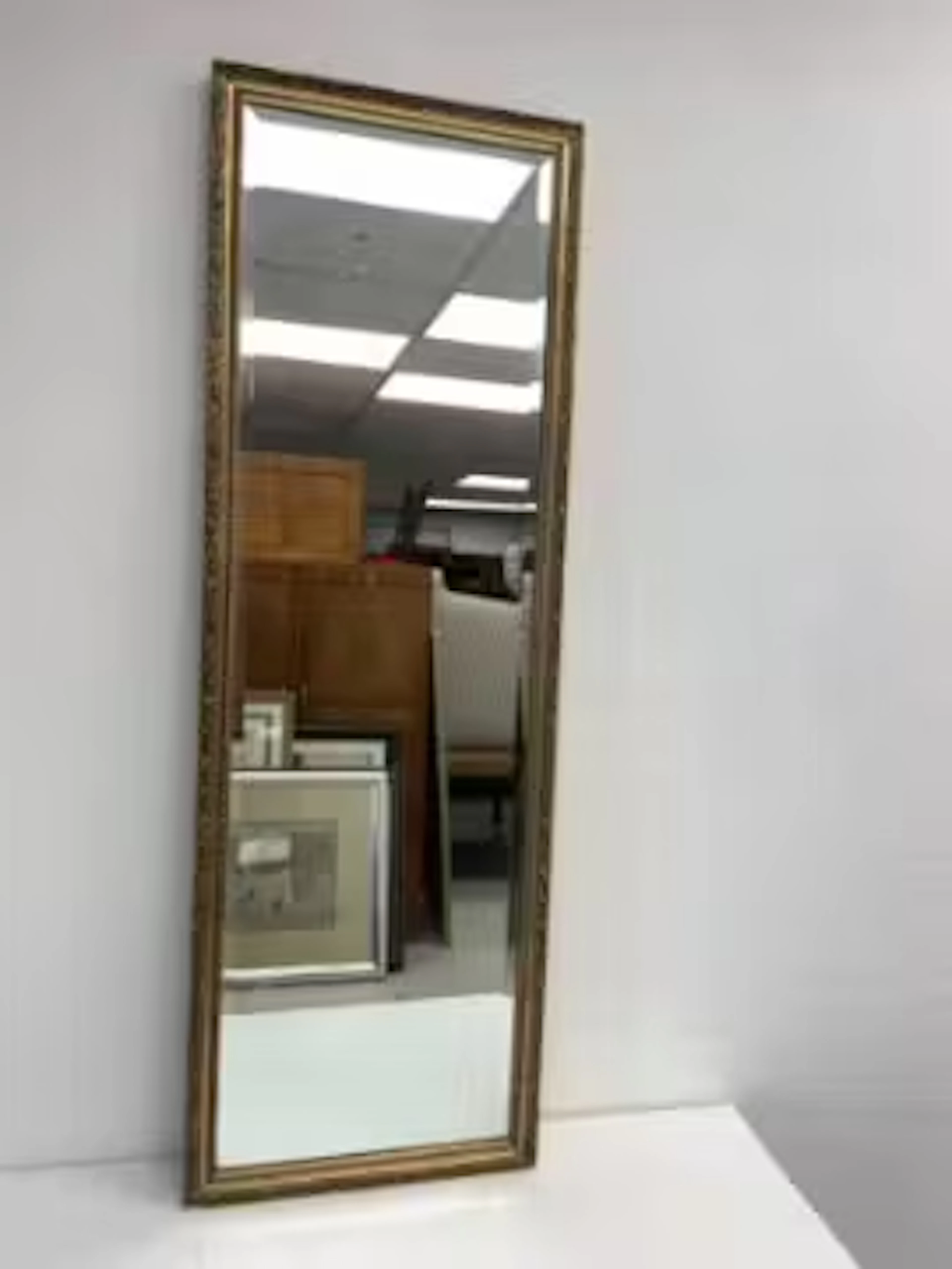 A vintage gilt framed dressing mirror with bevelled plate. 126x42cm.