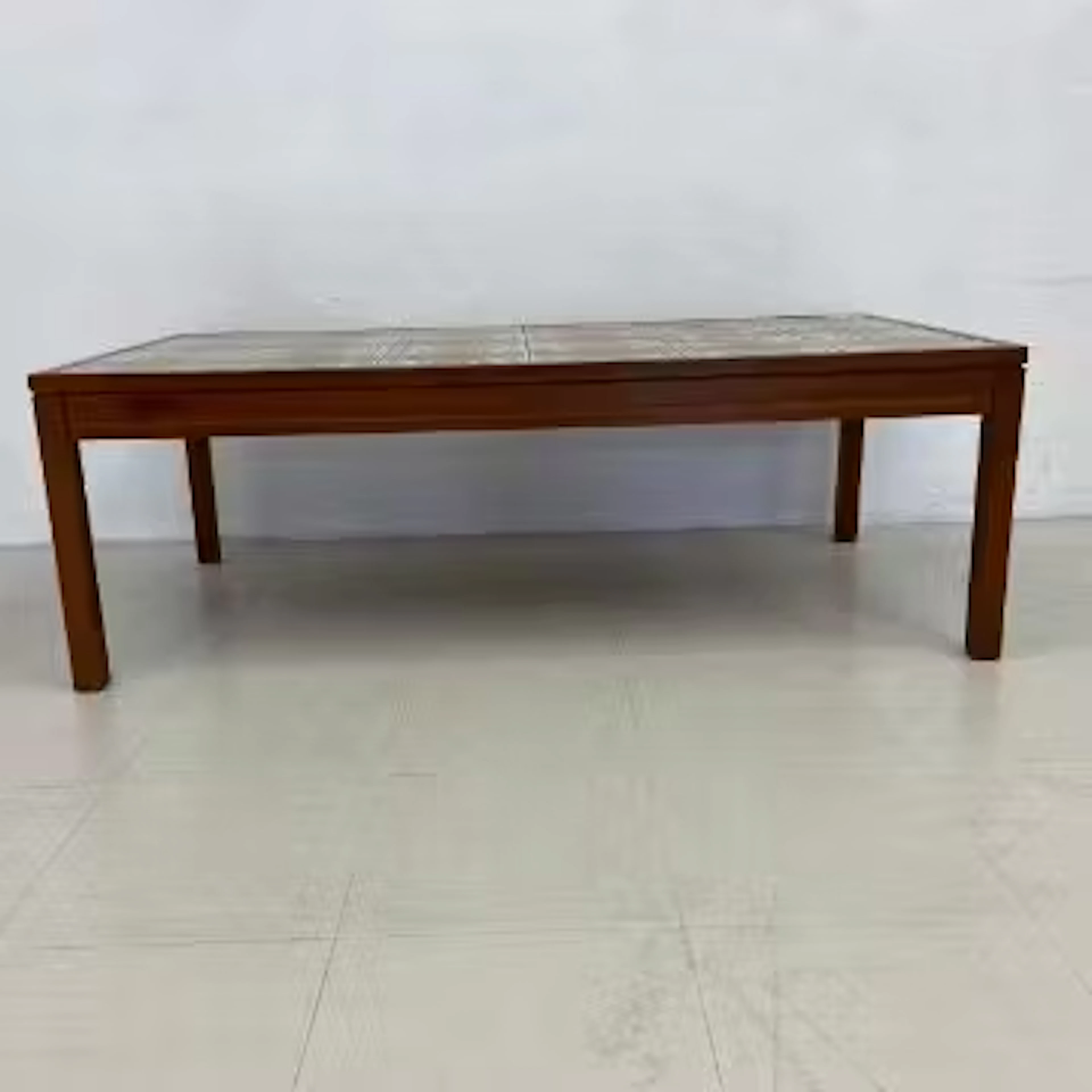 A mid-century teak coffee table with inset ceramic tile top. H.43