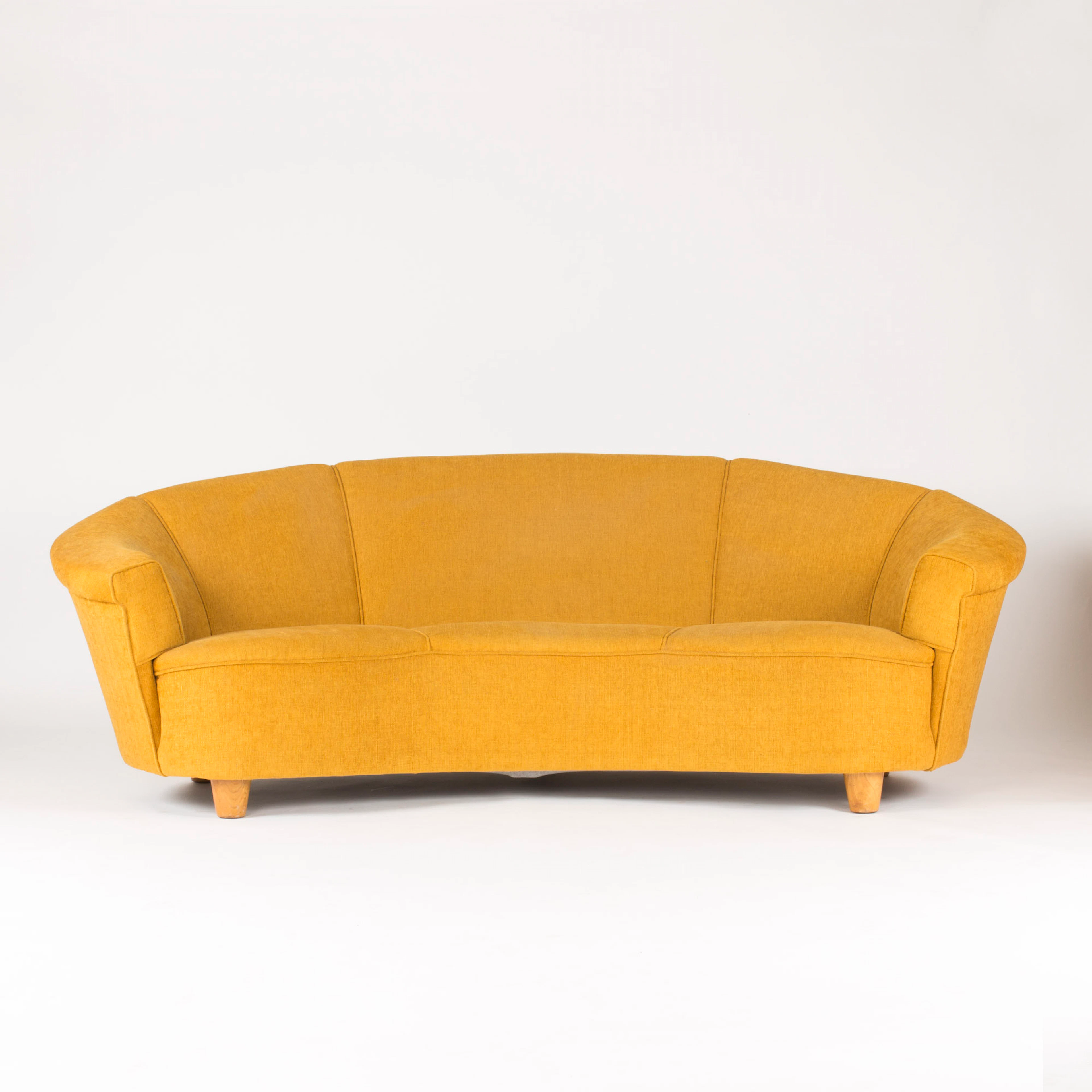 Arched three-seat sofa in the style of Otto Schulz