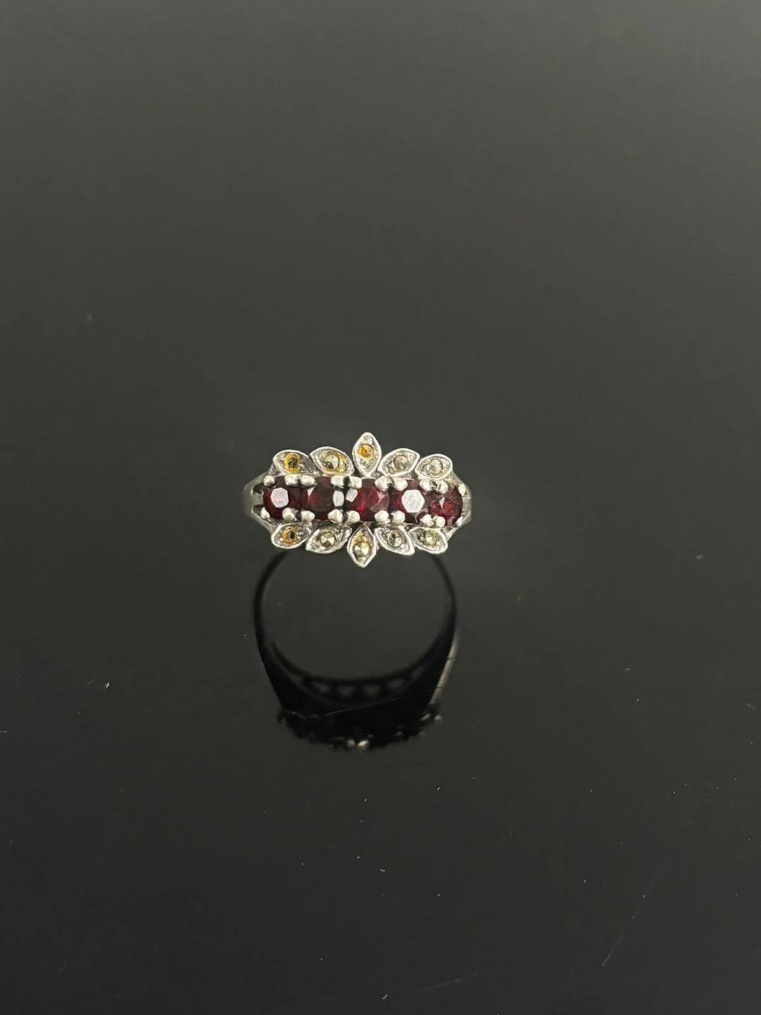 NV Silver ring set with a row of red stones flanked by white - Lot 175